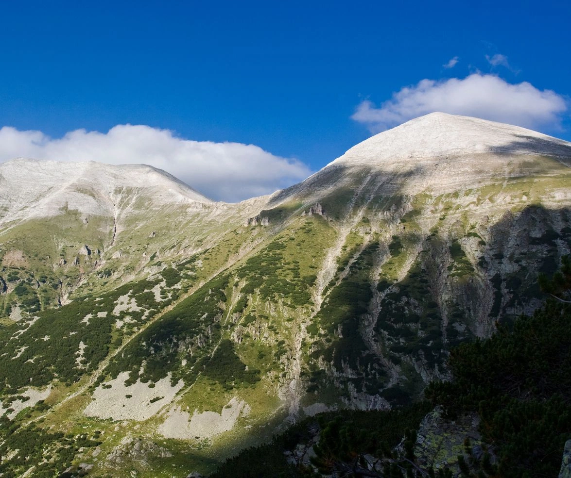 Twin limestone peaks of Vihren and Kutelo in Bulgaria’s Pirin range under a bright blue sky