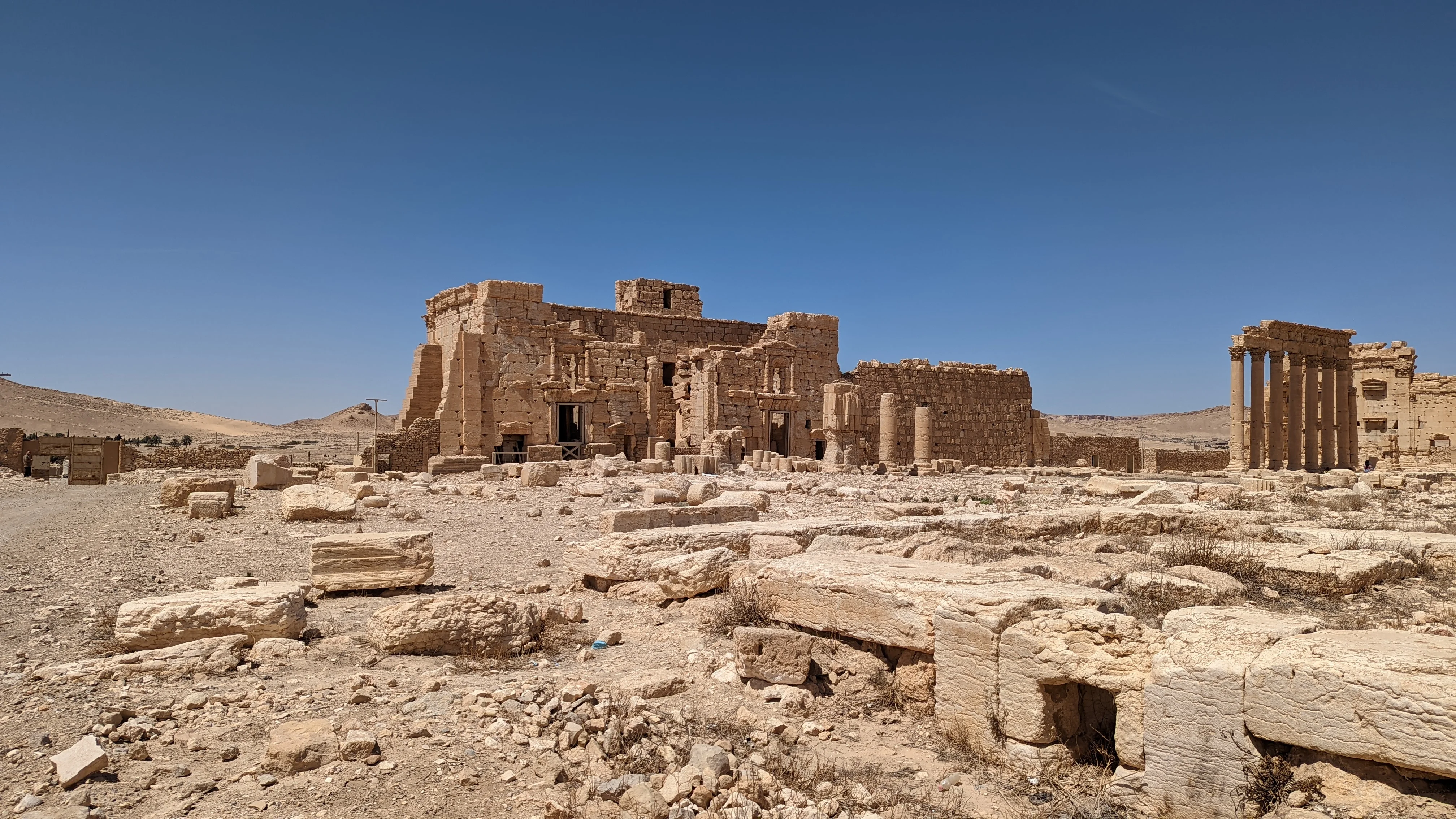 Ruins of ancient Palmyra temple complex under clear desert sky on Syria cultural tour