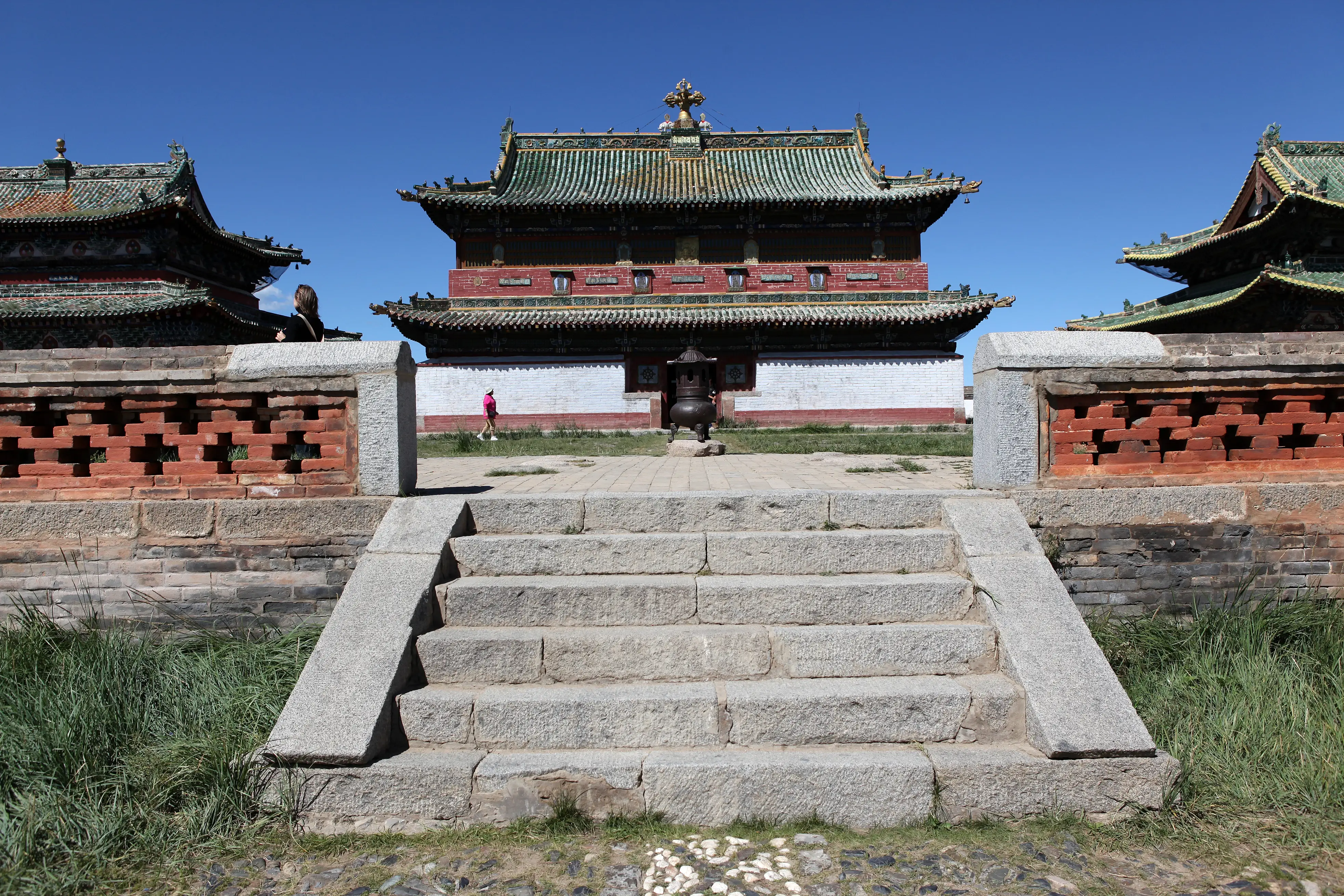 Front steps of Erdene Zuu Monastery temple with green tiled roof.