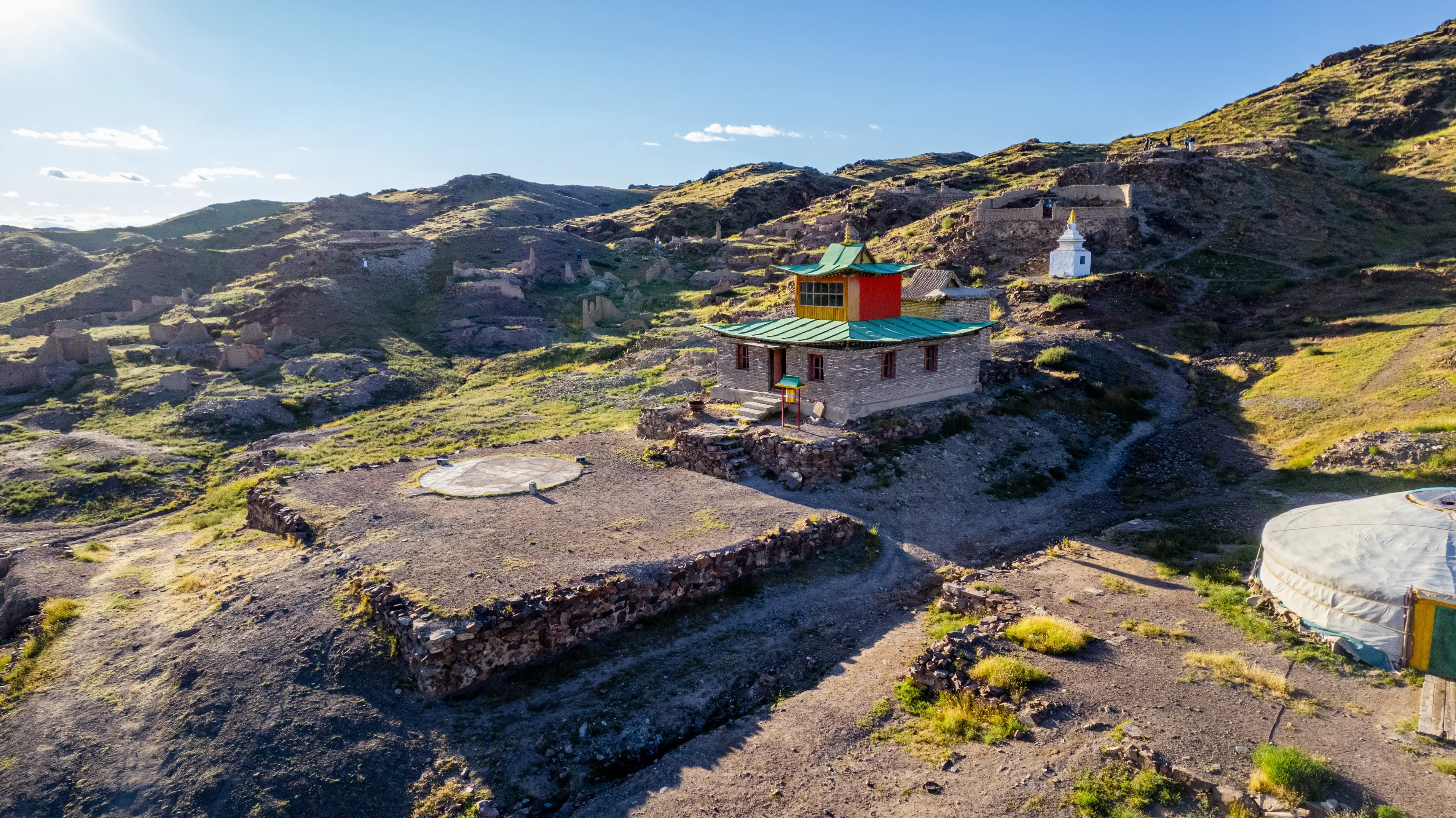 Old monastery building among ruins of Karakorum under clear sky.