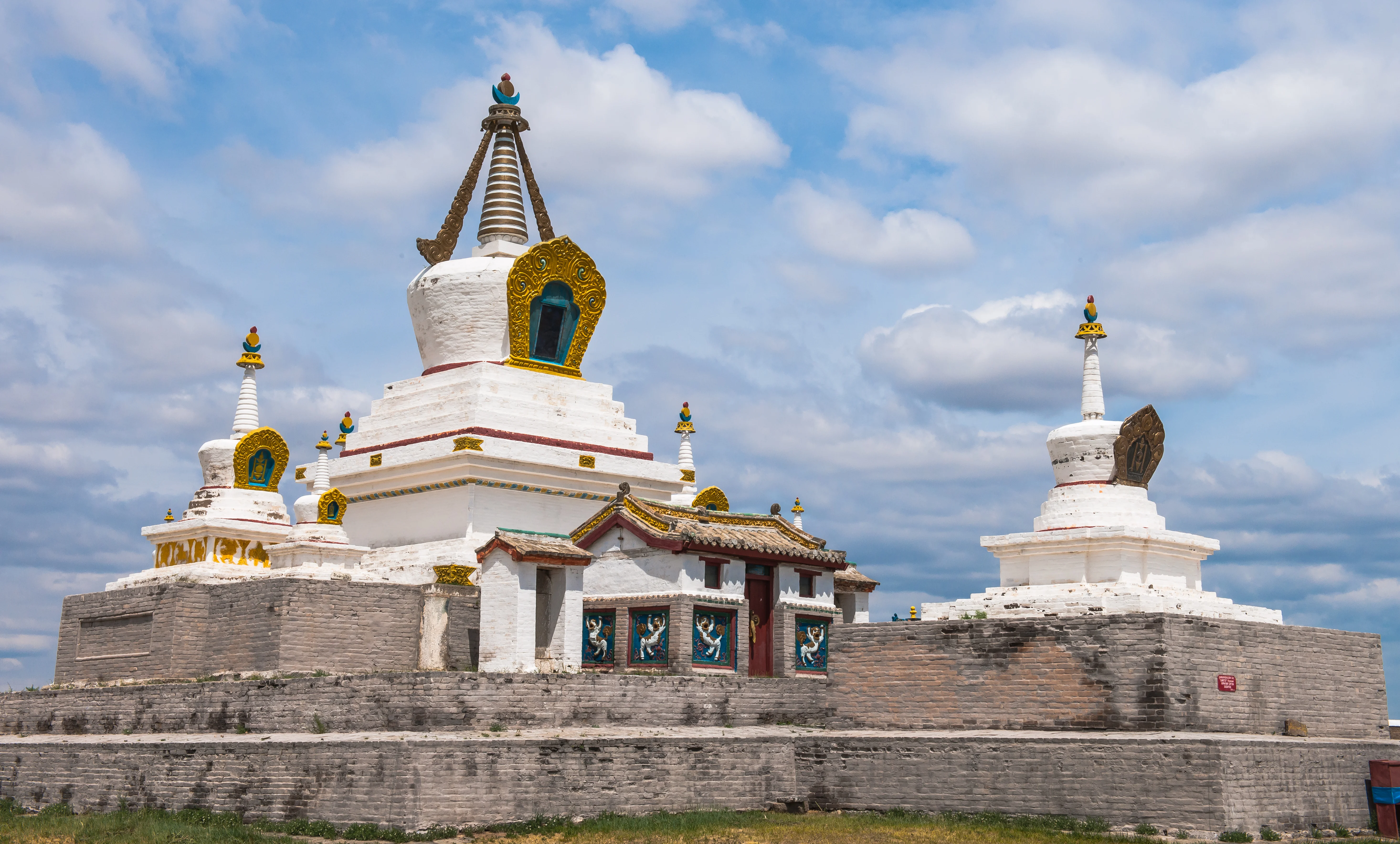 Erdene Zuu Monastery's white stupas and temple with golden decorations.