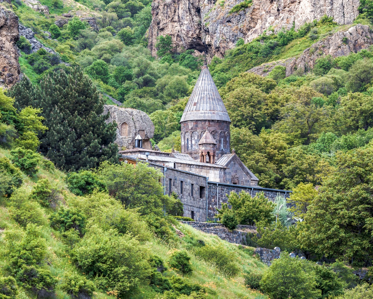 Geghard Monastery, Armenia - Medieval rock-hewn monastery nestled in lush green mountains of Armenia.