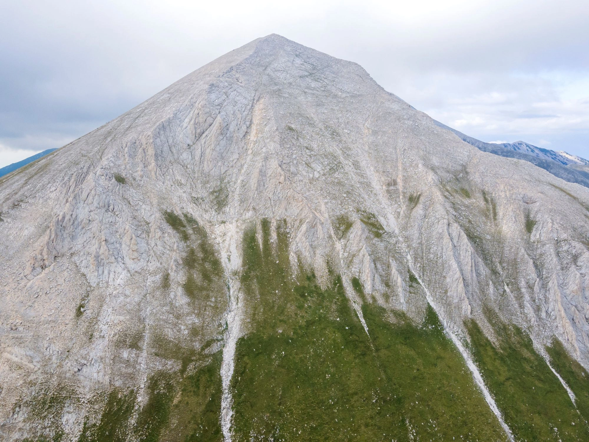Hiking trail in Pirin Mountain, Bulgaria, winding through alpine meadows and leading to towering peaks.