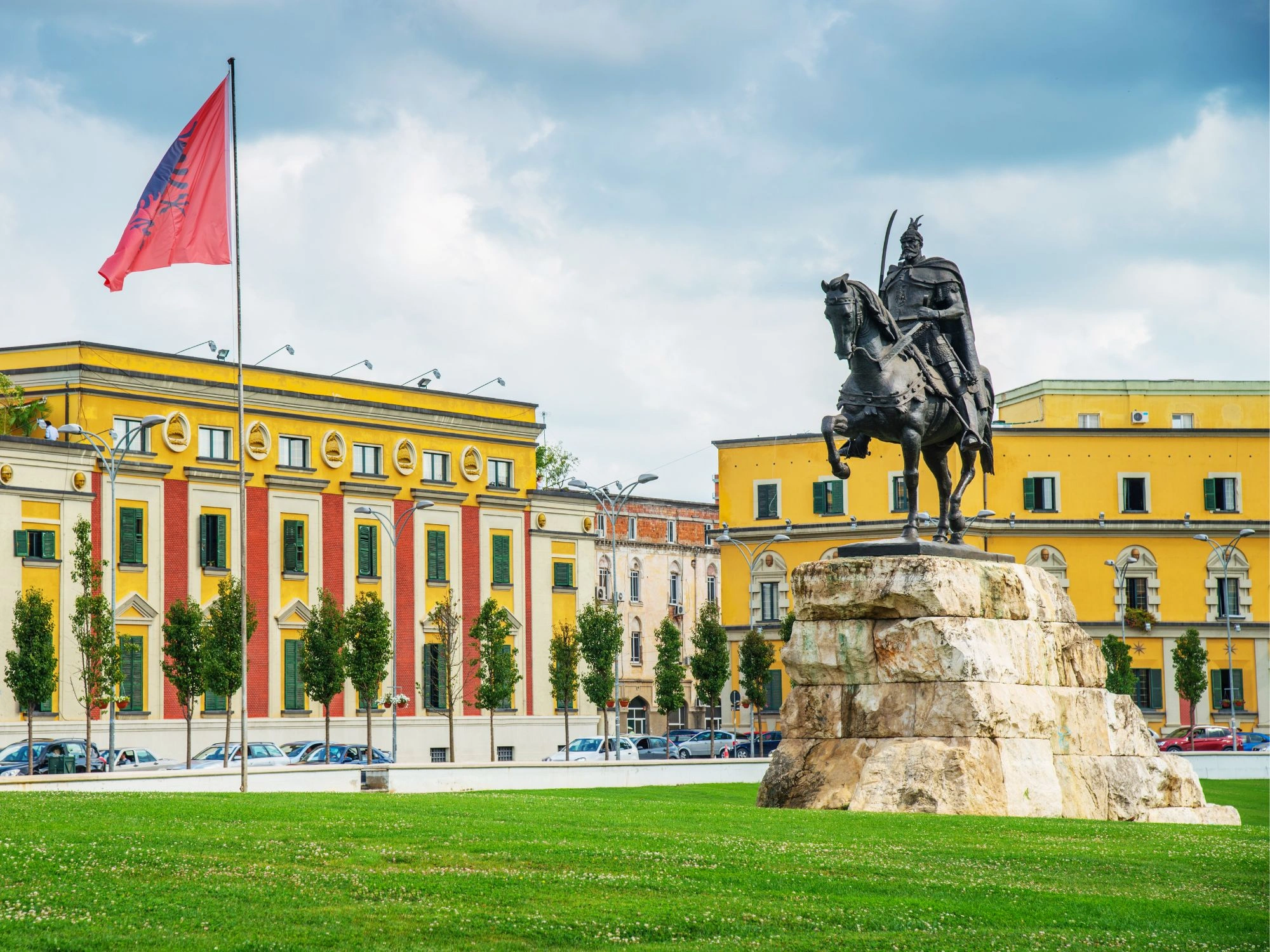 Skanderbeg Square in Tirana, Albania, featuring the iconic equestrian statue and colorful government buildings.