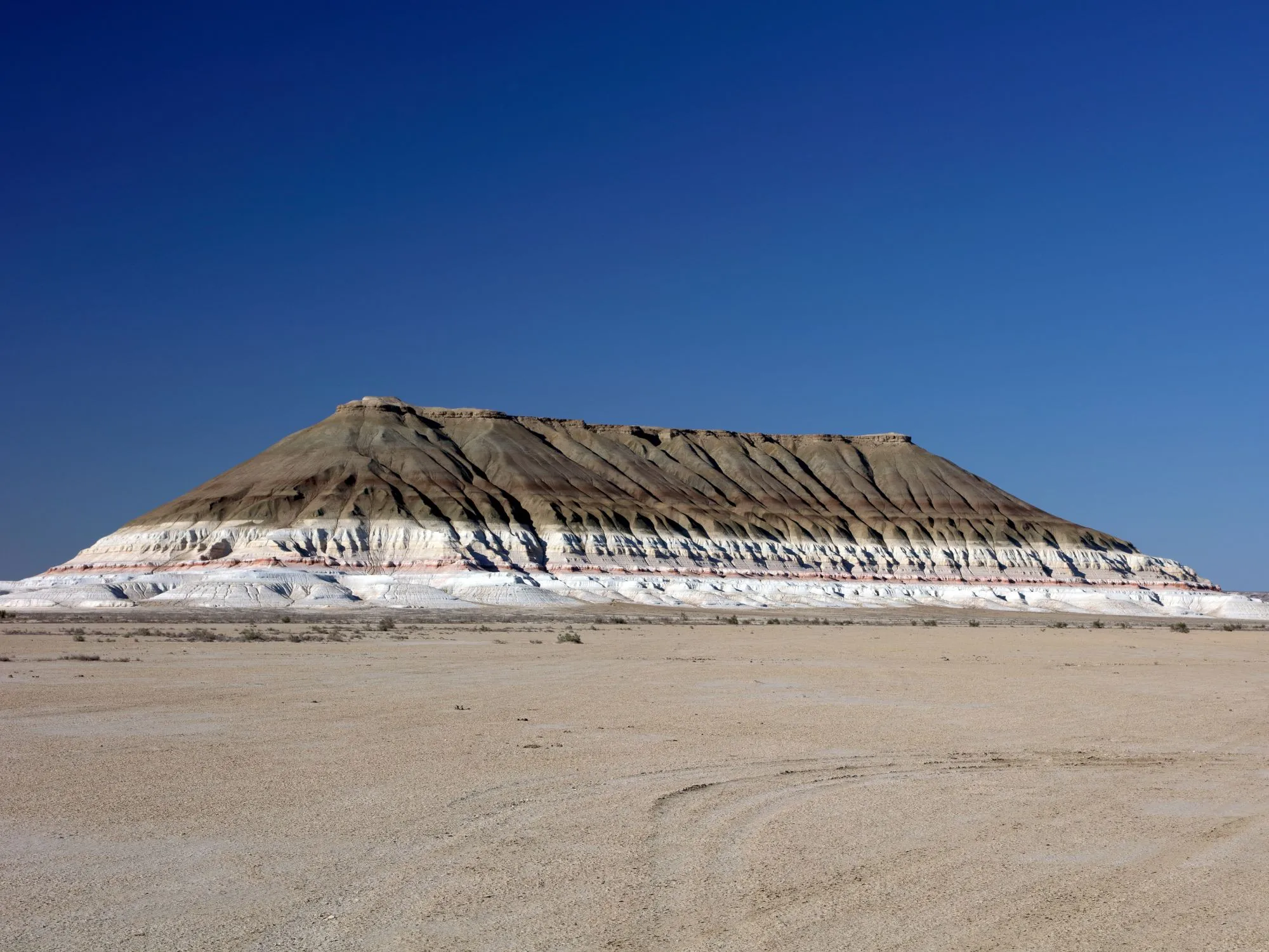 Mount Bokty in Kazakhstan, a strikingly isolated, flat-topped peak with sharp ridges rising from the surrounding plains.