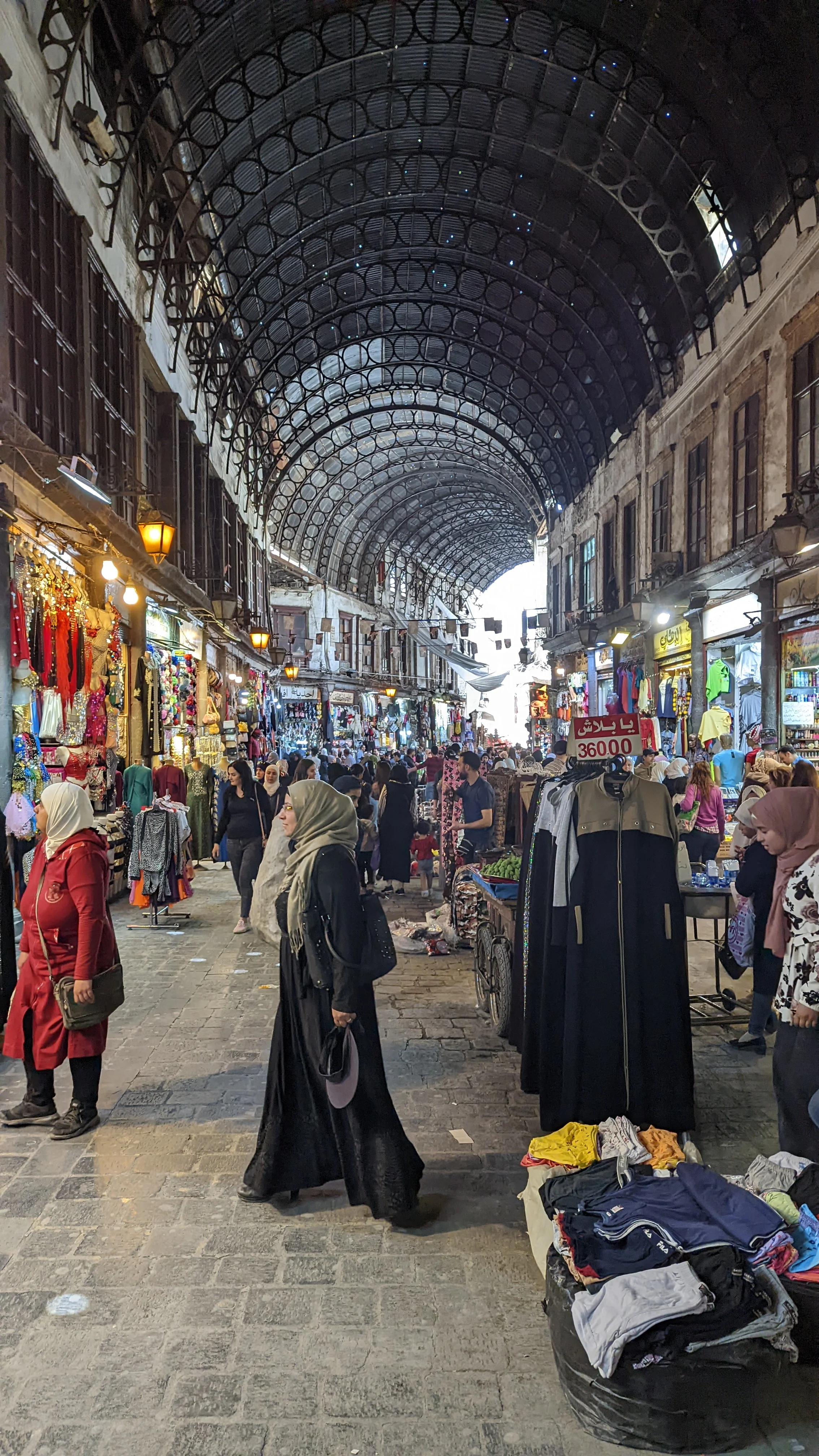 Bustling Al-Hamidiyah Souq in Damascus filled with shoppers and colorful market stalls