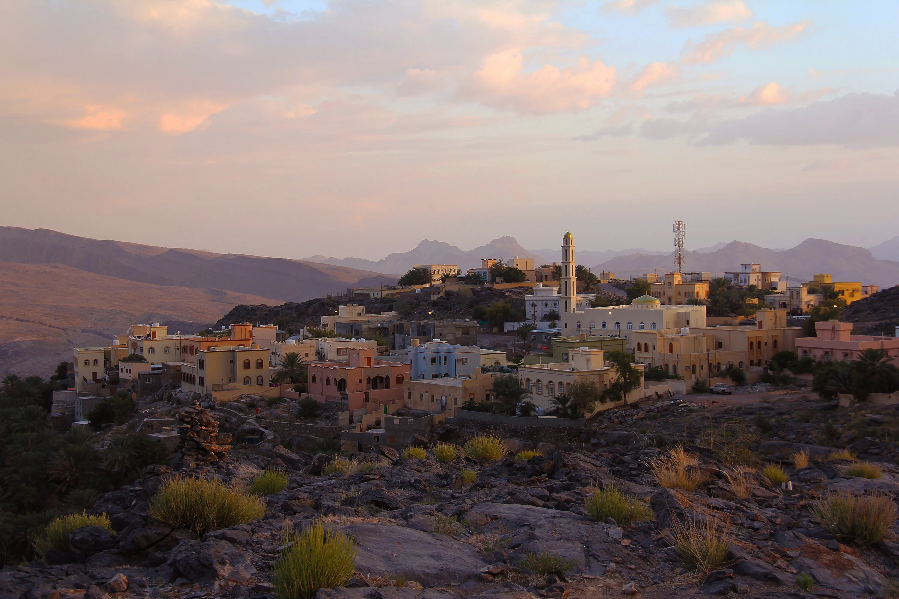 Colorful mountain village at sunset in Al Hamra seen during an Oman tour.