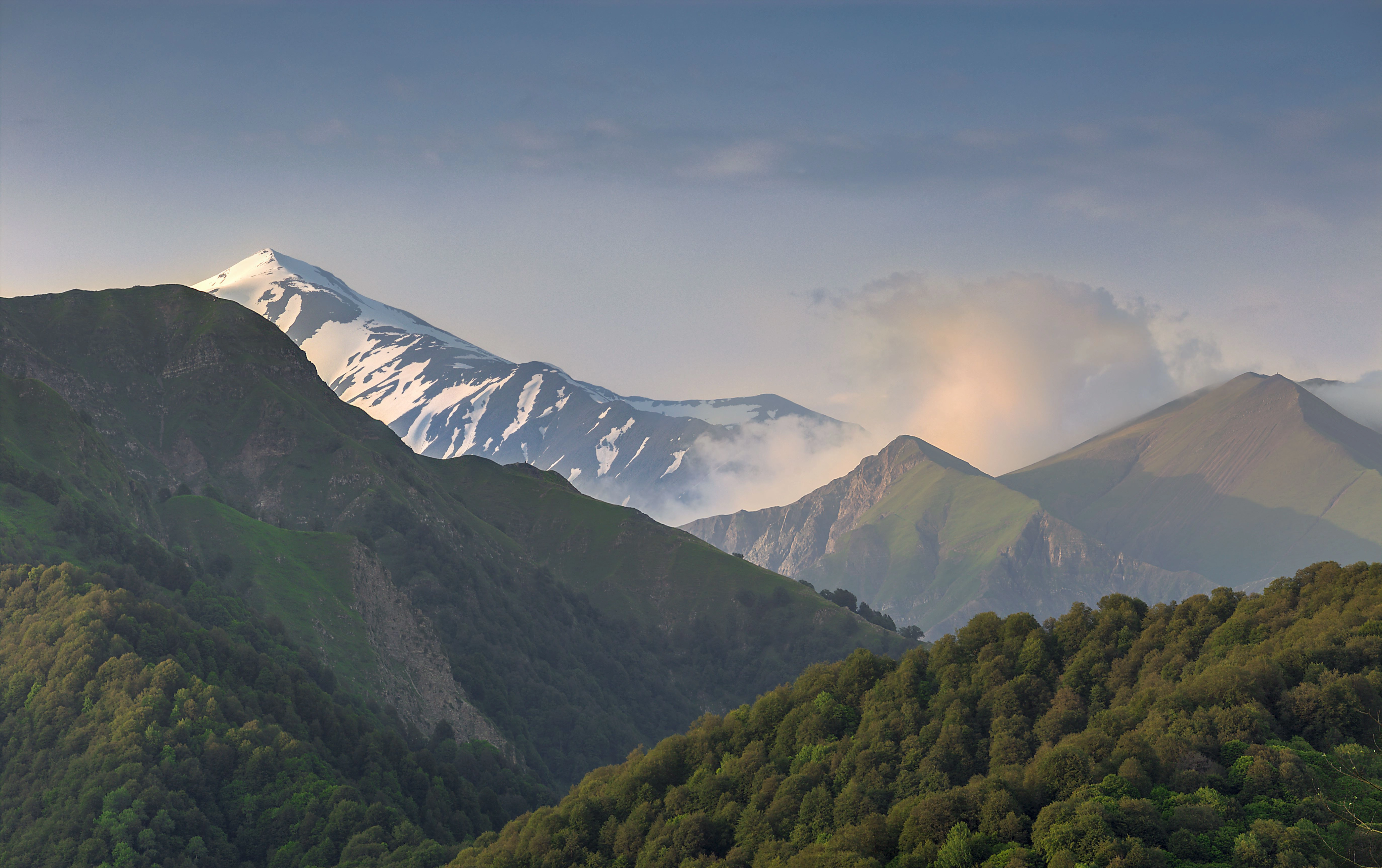 Snow-capped peaks and lush green valleys of the Greater Caucasus Mountains in Azerbaijan