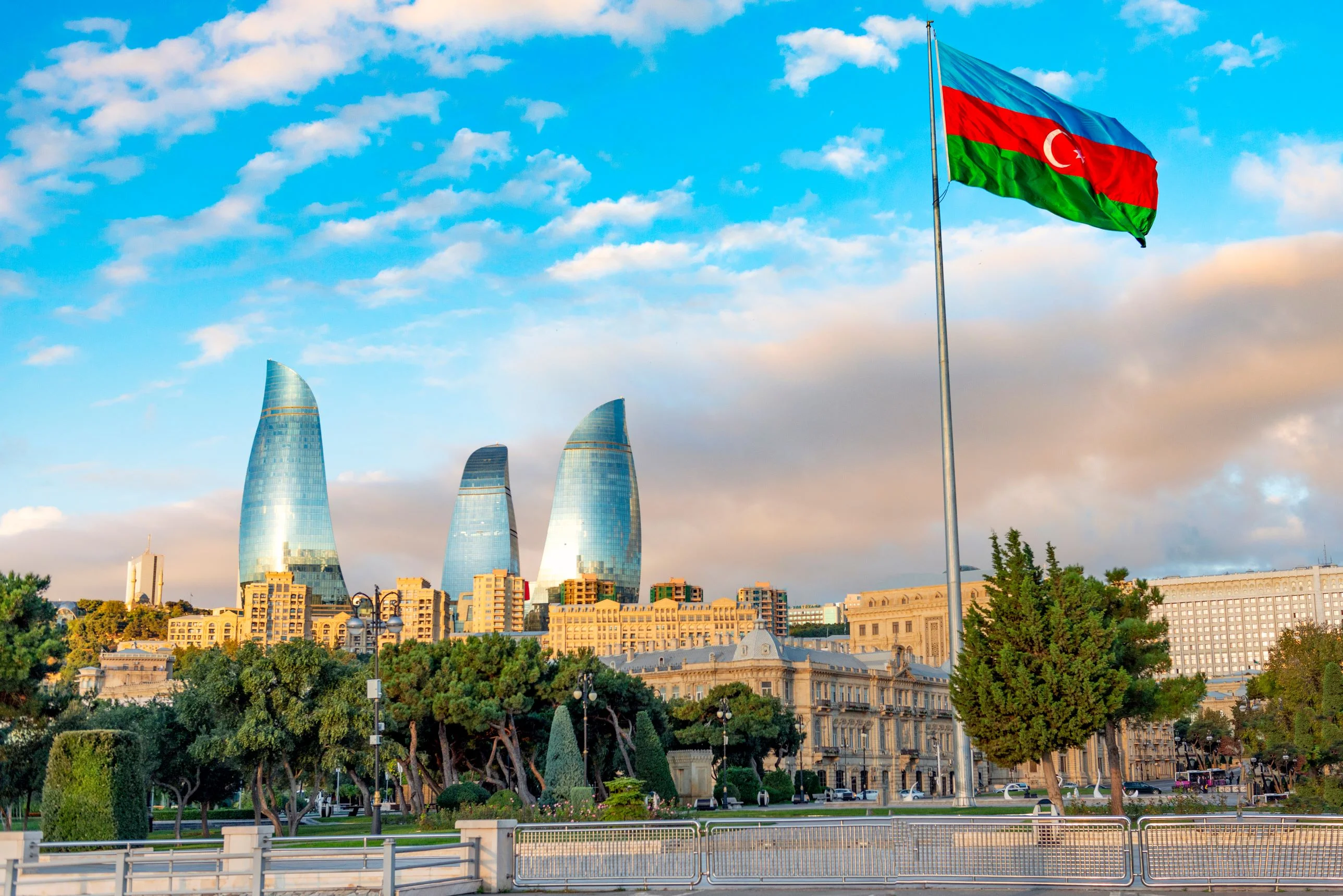 Baku Flame Towers – Azerbaijan’s soaring Flame Towers skyscrapers with the national flag of Azerbaijan waving in the foreground.