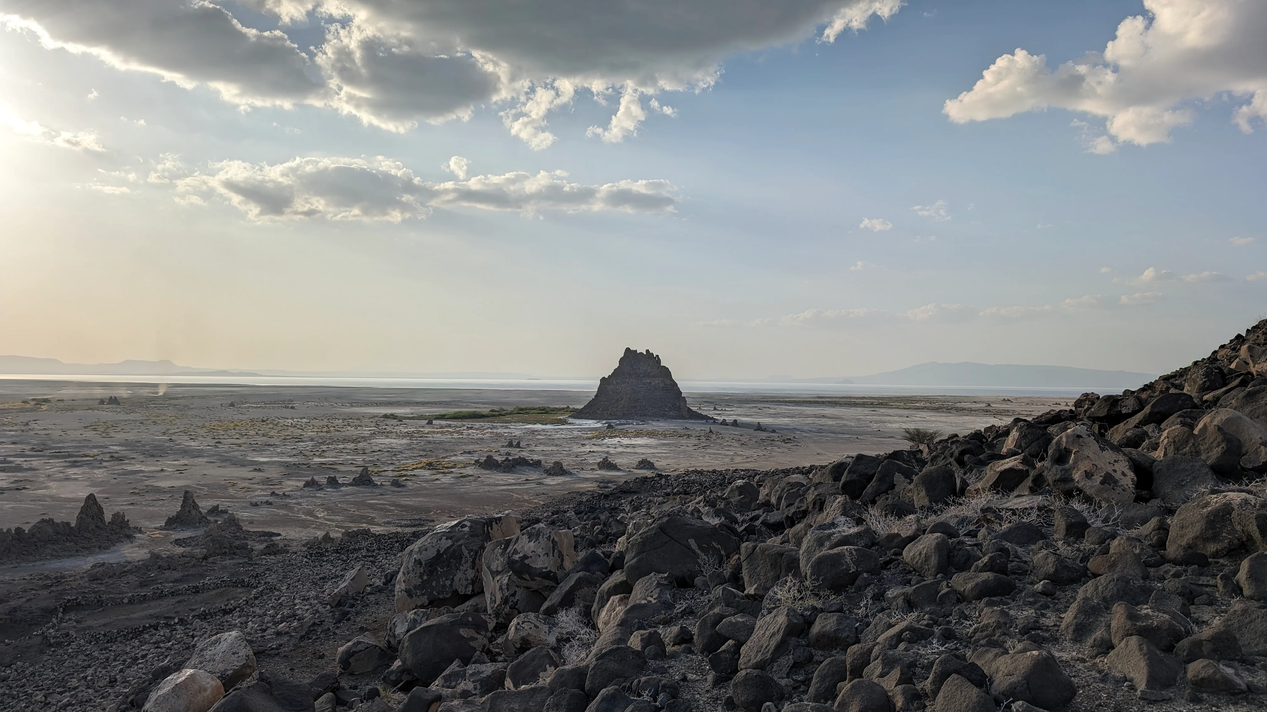 Rocky volcanic mound under cloudy sky at Lake Abbe in Djibouti.