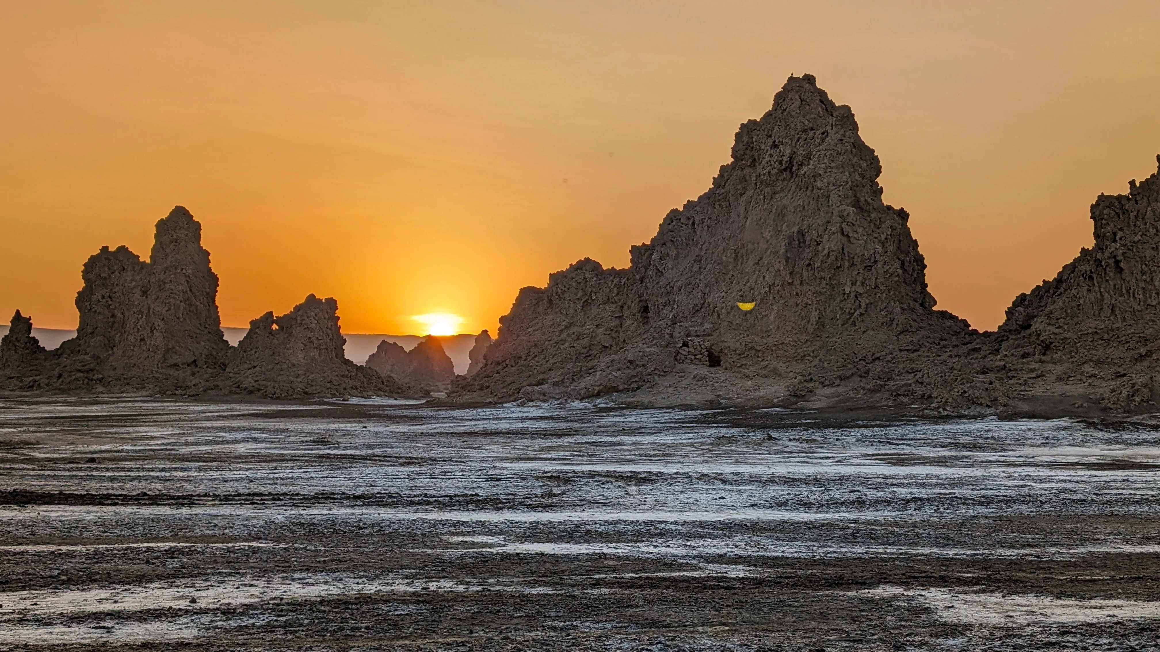 Sunset behind limestone chimneys at Lake Abbe in Djibouti travel adventure.