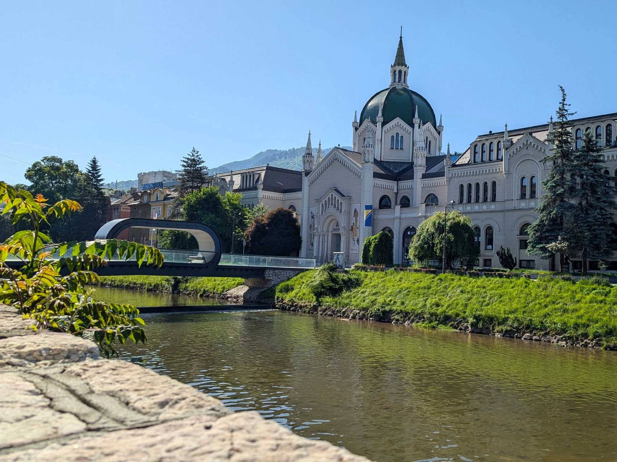 Festina Lente pedestrian bridge and Academy of Fine Arts on the Miljacka River in Sarajevo, Bosnia and Herzegovina.