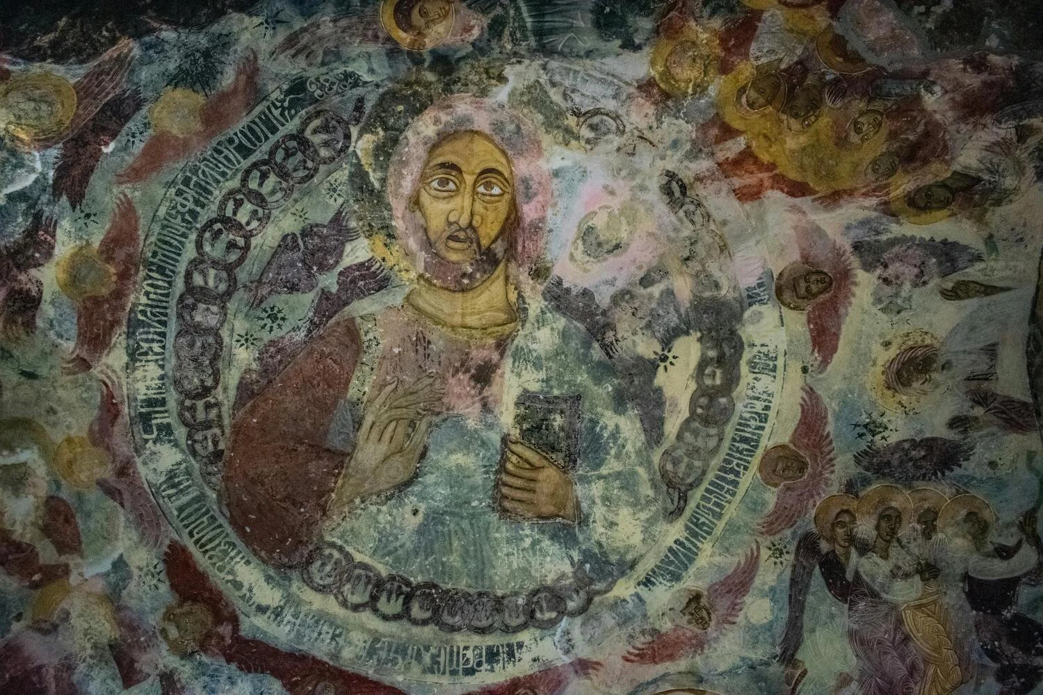 Faded Byzantine fresco of a haloed saint inside Sumela Monastery, weathered by centuries on rock-cut walls