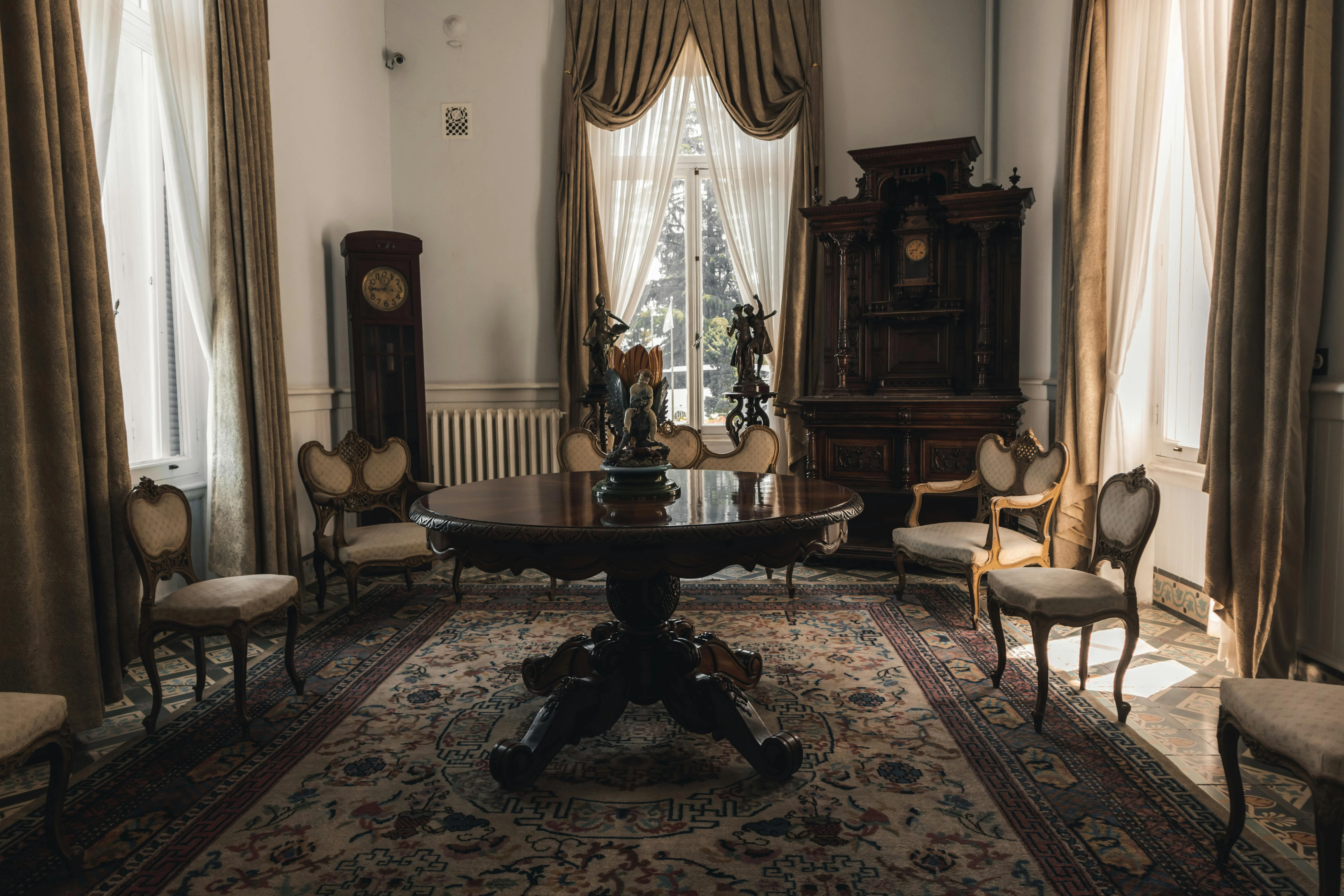 Elegant vintage parlour with chandelier, dark wood furniture and oriental rugs in a historic Black Sea mansion