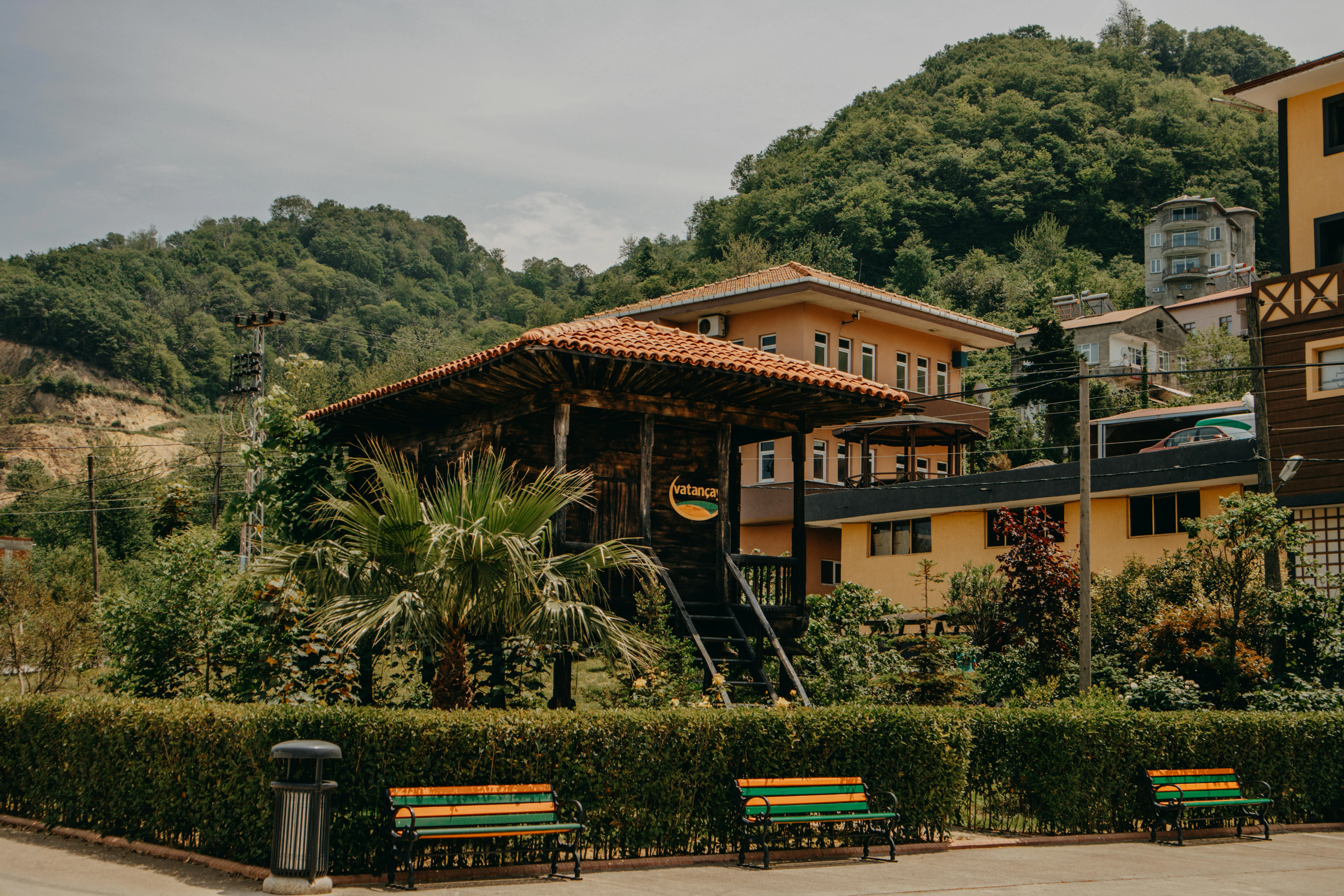 Traditional wooden Black Sea Turkish house with covered porch and tile roof, set in a quiet forested village