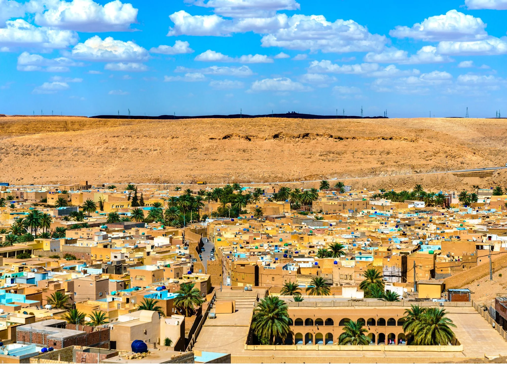 Panoramic view of Ghardaia, a Mozabite oasis town of mud-brick houses and palms below desert plateau