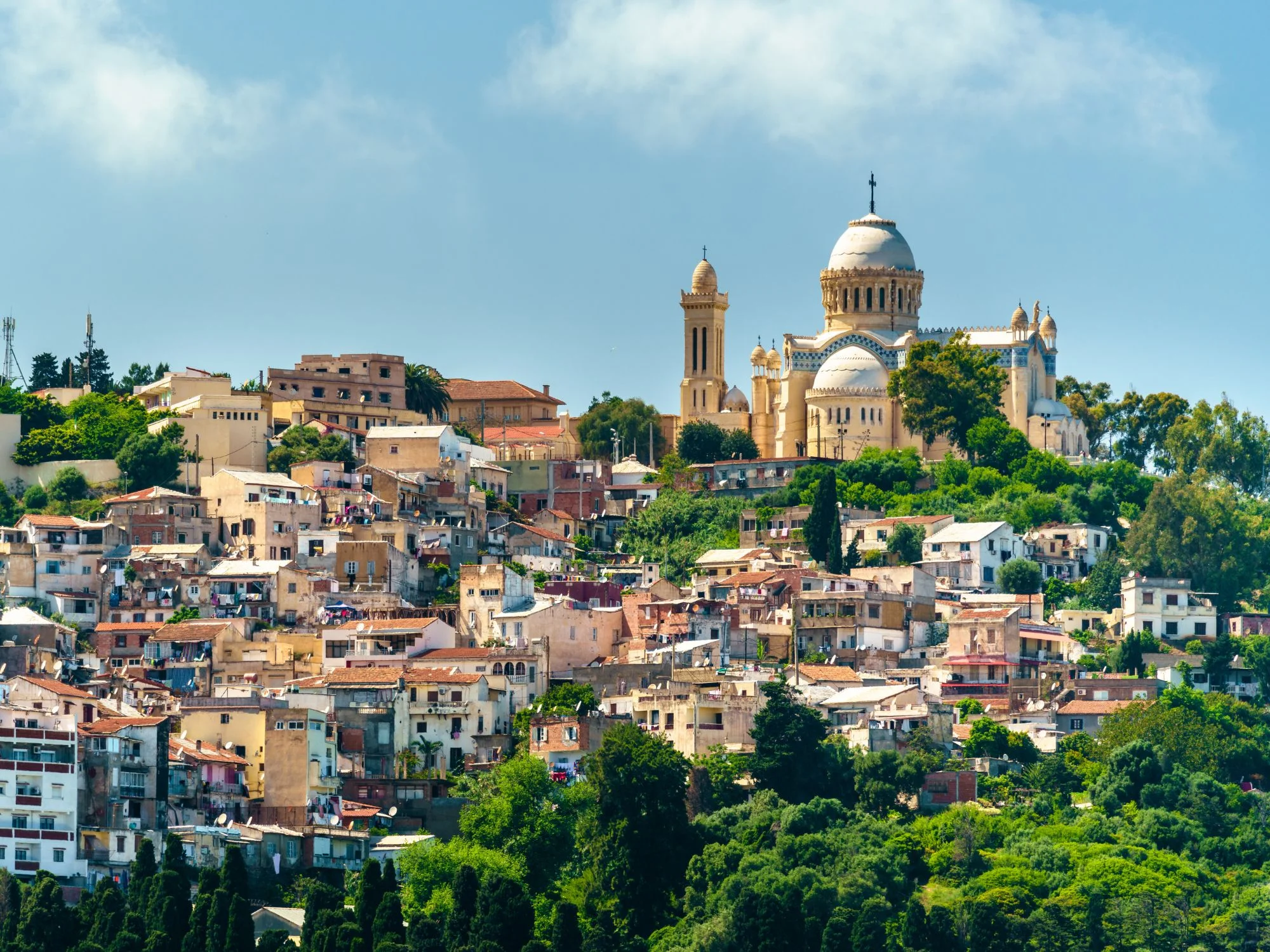 Notre-Dame d'Afrique basilica with its slate-blue dome above the hillside houses of Algiers