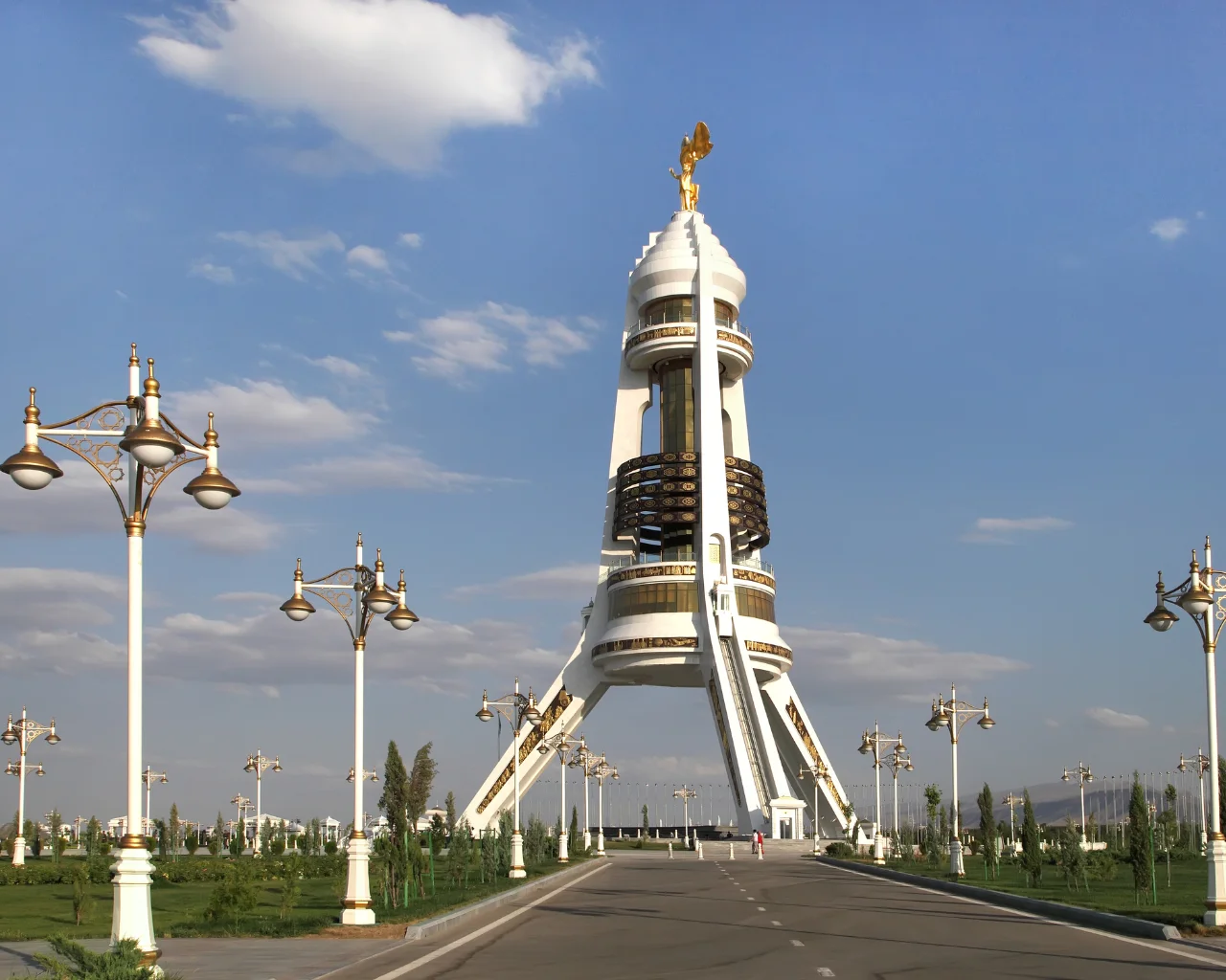 White and gold Arch of Neutrality monument topped with a golden statue, Ashgabat, Turkmenistan