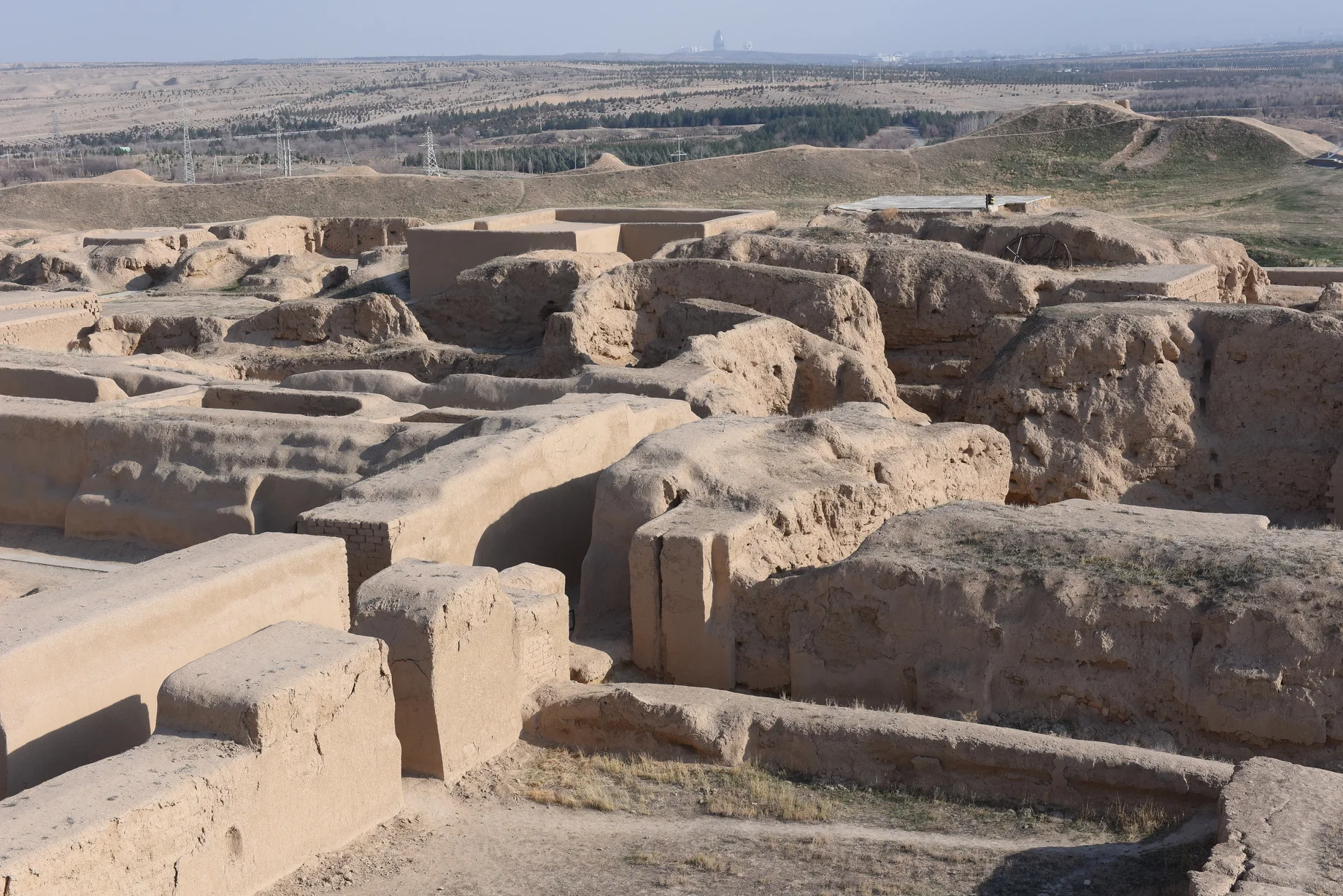 Earthen ruined walls of the ancient Parthian fortress of Nisa with foothills beyond, Turkmenistan