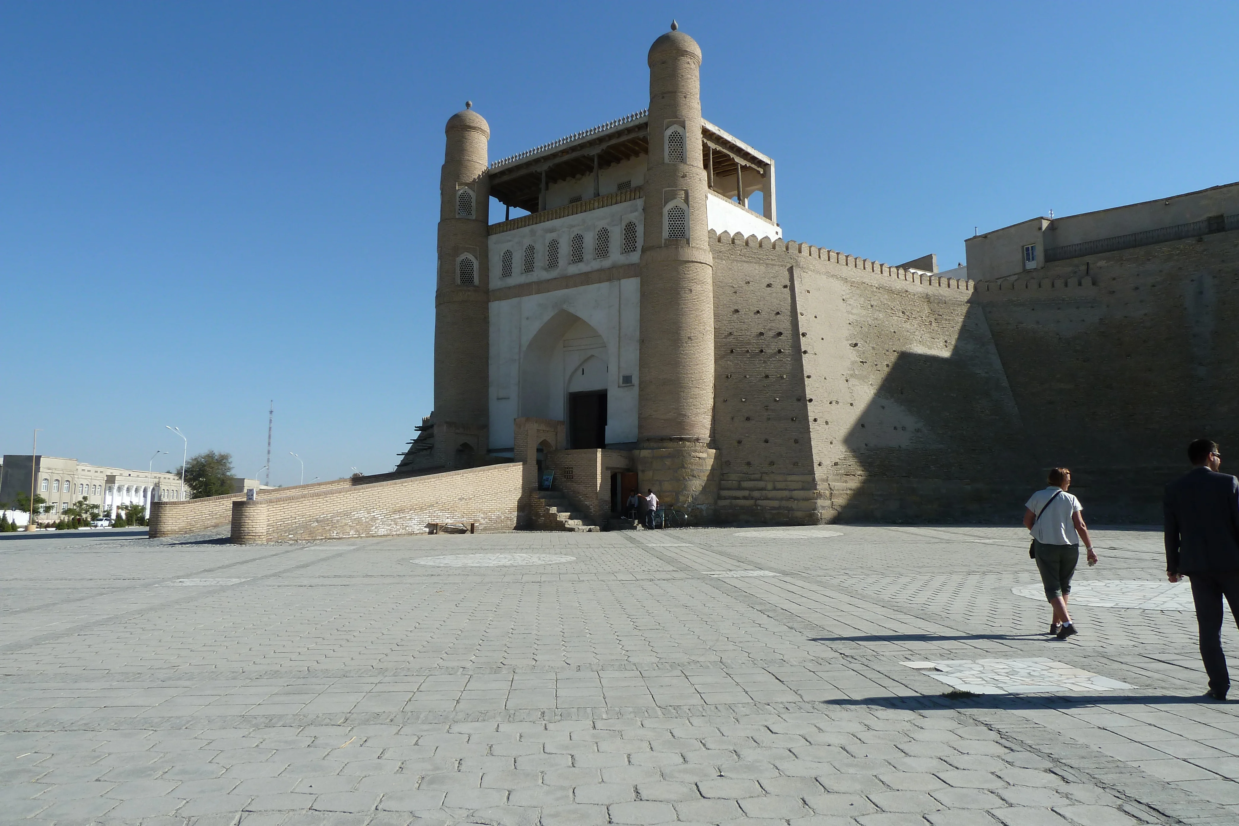 Massive fortified gate of the Ark of Bukhara with twin towers and stone-paved square, Uzbekistan