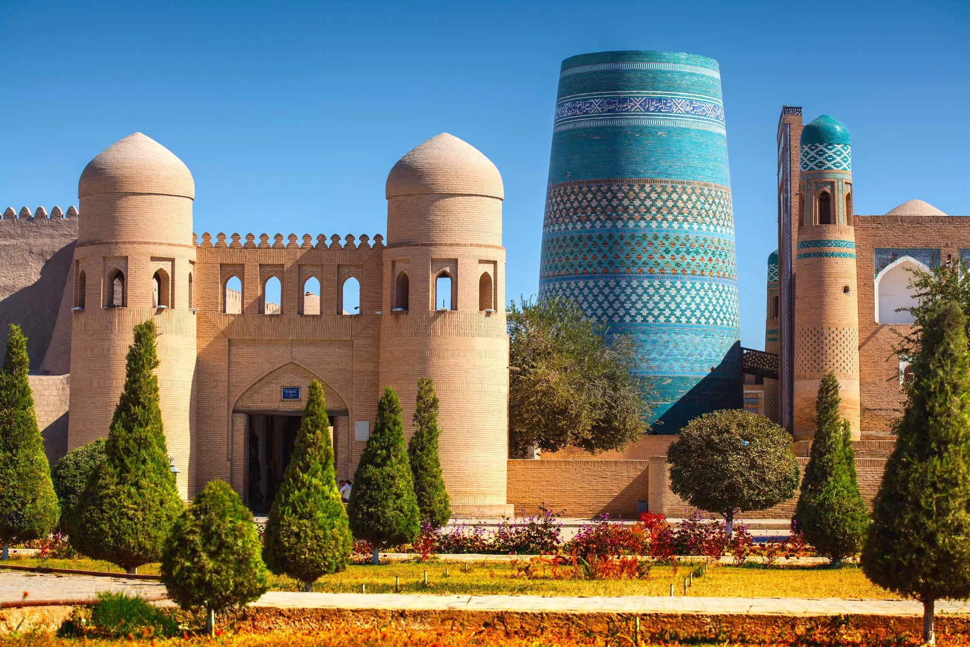 West gate of Ichan-Kala beside the tiled Kalta Minor minaret in Khiva, Uzbekistan