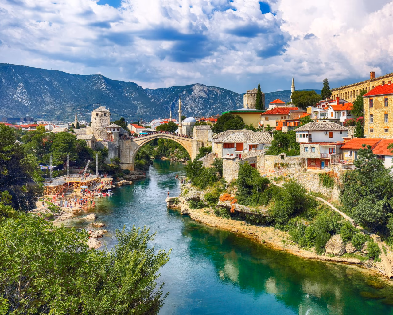 Stari Most bridge arching over the emerald Neretva River amid the historic old town of Mostar, Bosnia and Herzegovina.