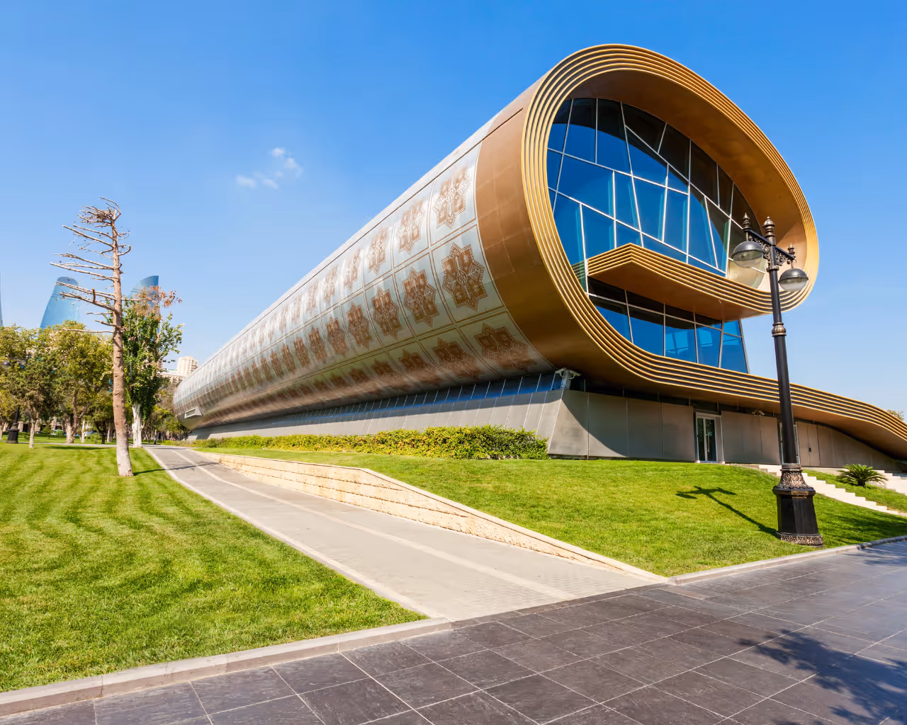 Azerbaijan Carpet Museum in Baku, a uniquely curved building resembling a rolled-up carpet with intricate patterns.