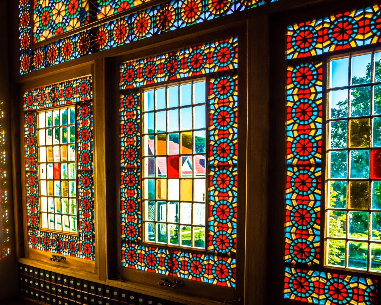 Colorful stained glass shebeke windows of Sheki Khan’s Palace in Azerbaijan with sunlight reflections
