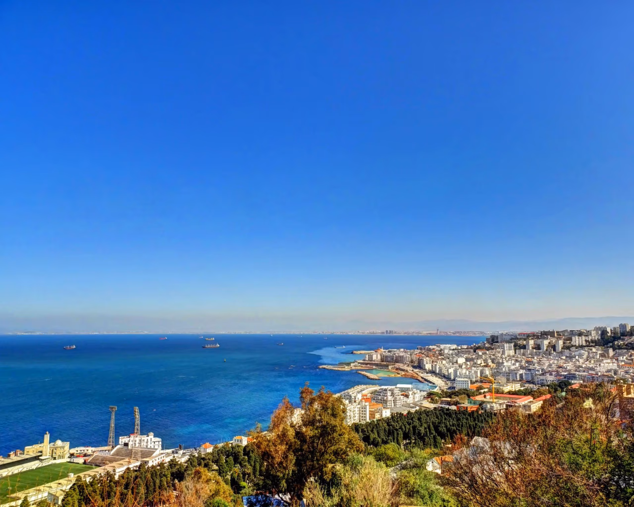 Sweeping view from the Algiers heights over the white-walled city and the wide Mediterranean bay