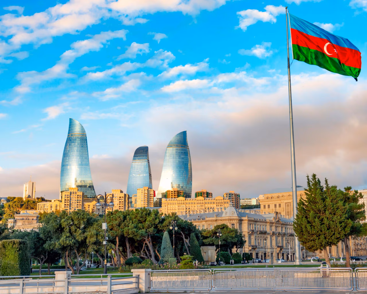 Baku Flame Towers – Azerbaijan’s soaring Flame Towers skyscrapers with the national flag of Azerbaijan waving in the foreground.