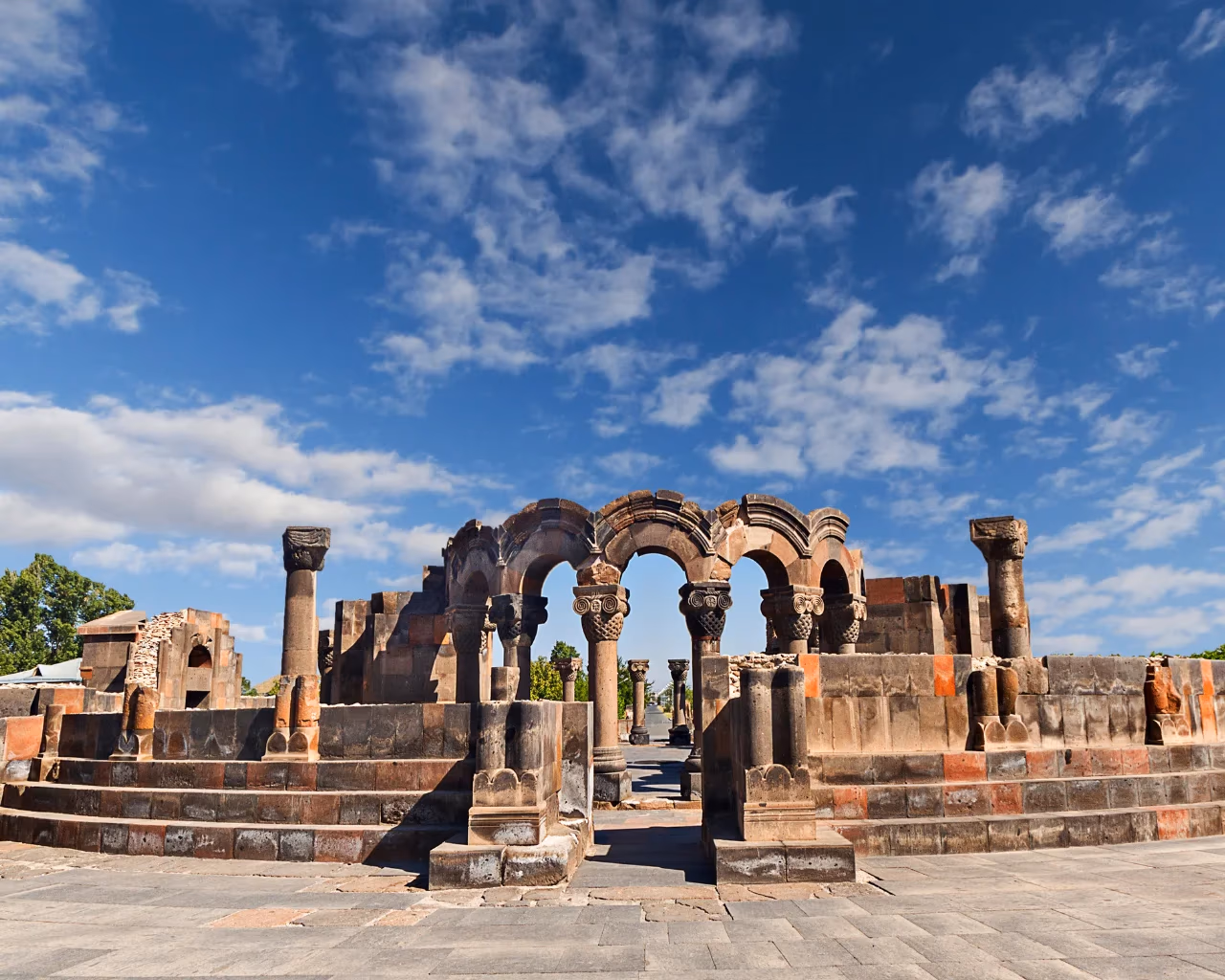 Zvartnots Cathedral ruins – stone arches and columns of the ruined 7th‑century Zvartnots Cathedral under a clear blue sky.