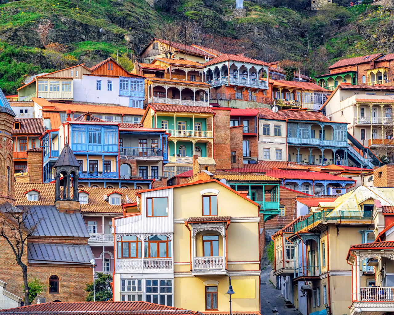 Tbilisi old town – colorful wooden balconied houses stacked on a hillside in the historic district of Georgia’s capital.