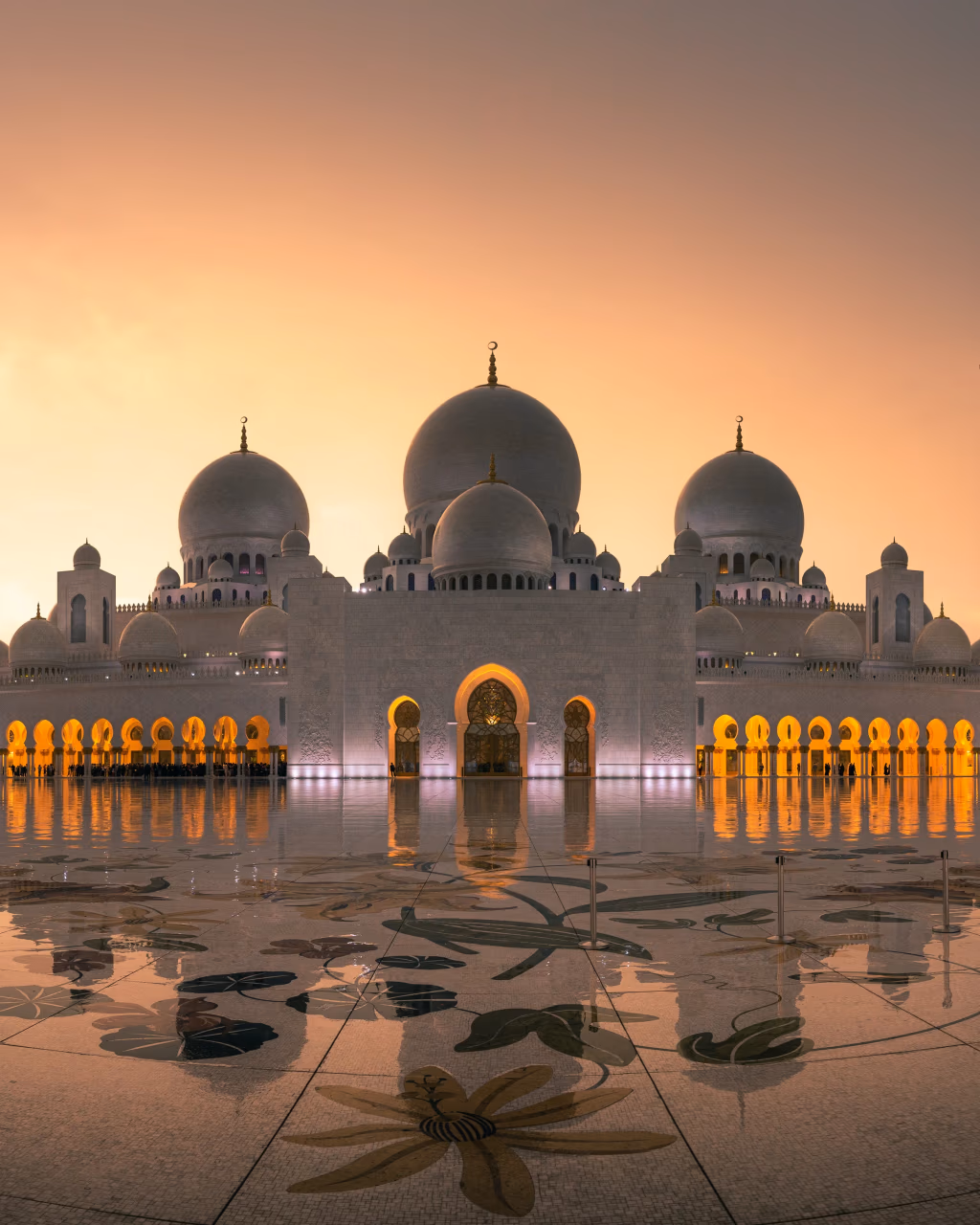 Sheikh Zayed Grand Mosque reflecting warm sunrise glow