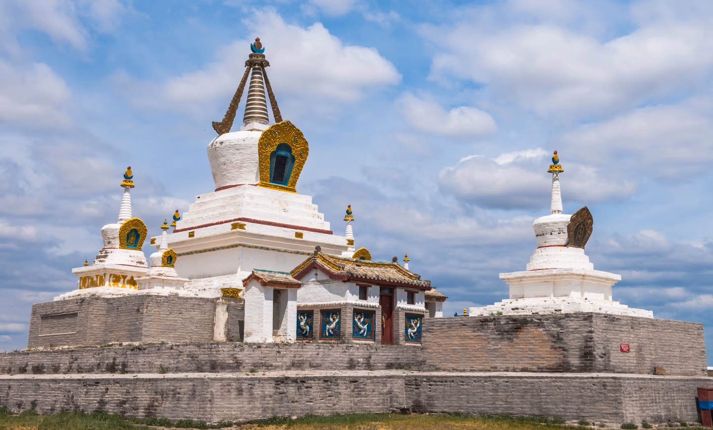 Erdene Zuu Monastery's white stupas and temple with golden decorations.