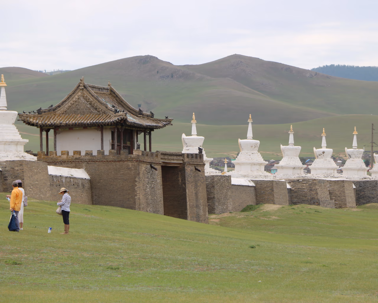 Erdene Zuu Monastery walls lined with stupas on Mongolian grasslands.