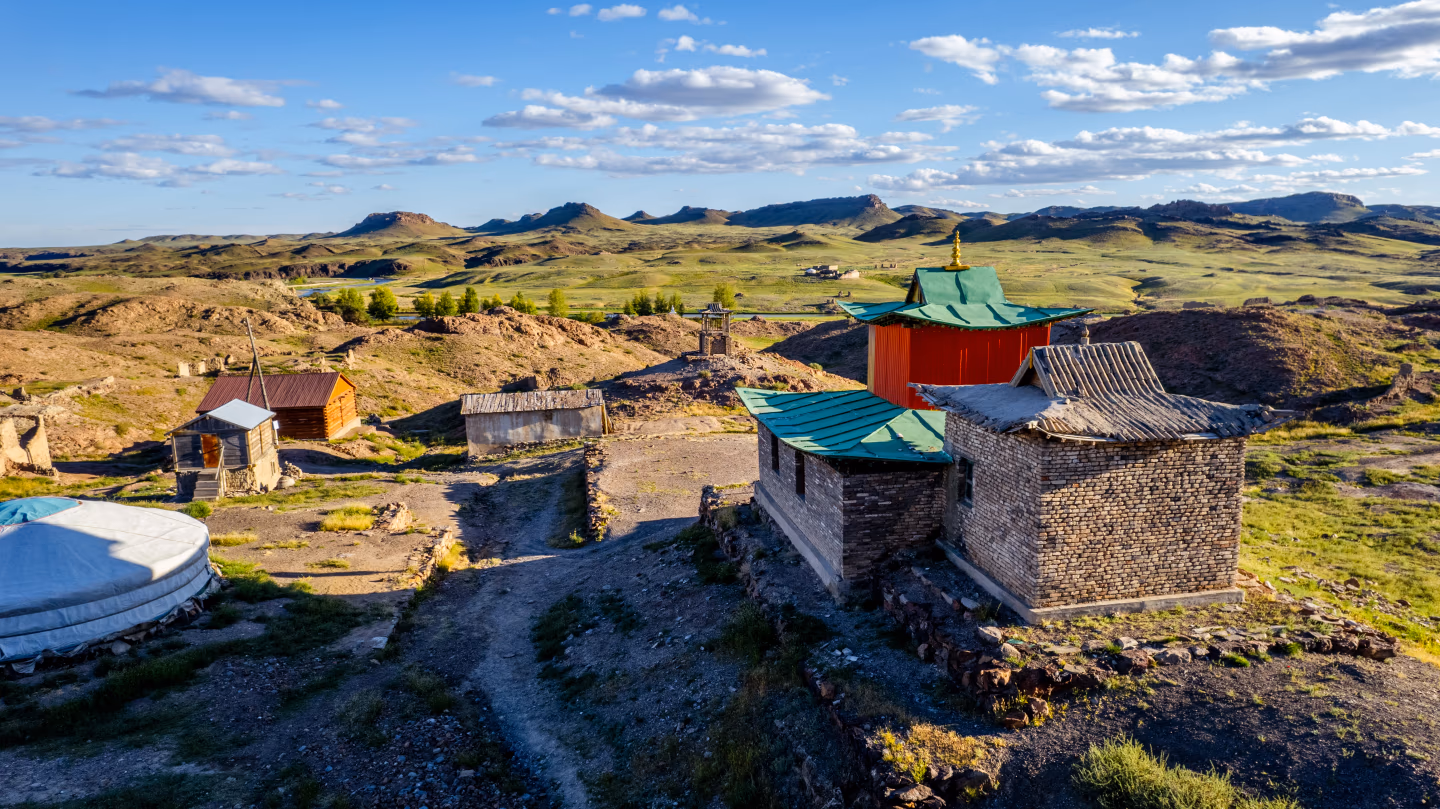 View over Karakorum temple roofs with Mongolia's green hills beyond.