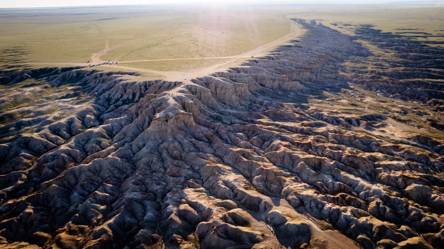 Aerial view of Mongolia's Flaming Cliffs with deep ridges and open plains.