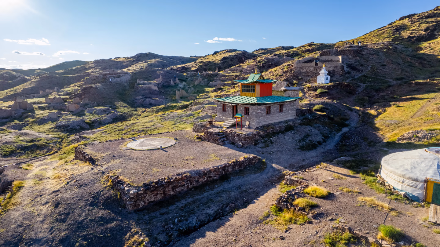 Old monastery building among ruins of Karakorum under clear sky.