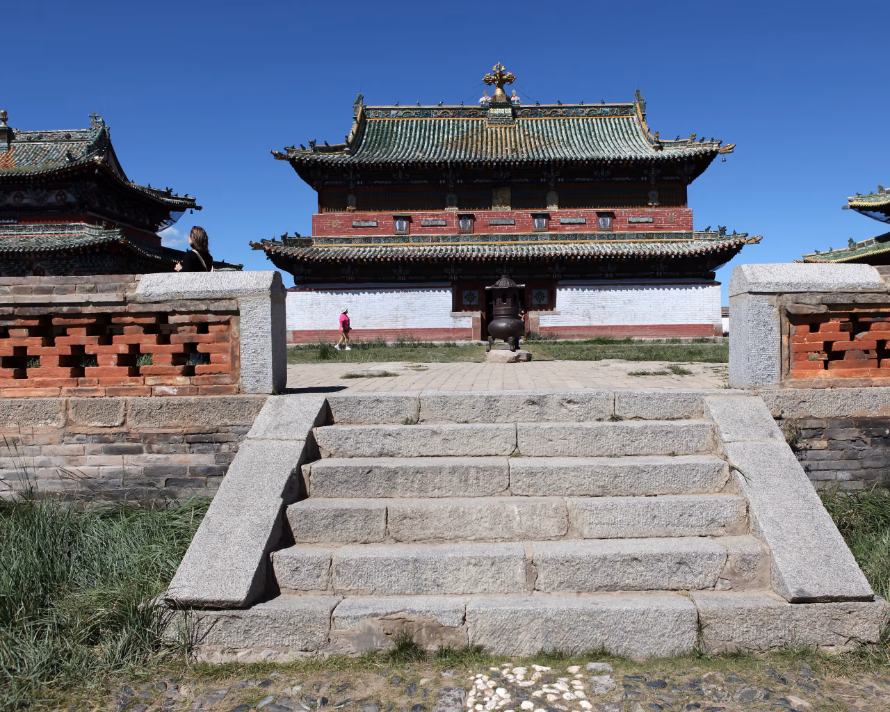 Front steps of Erdene Zuu Monastery temple with green tiled roof.
