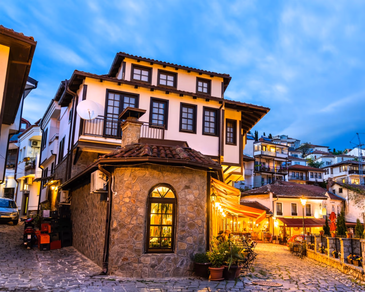 Cobblestone streets and cozy cafés in historic Old Town Ohrid, North Macedonia, at sunset.