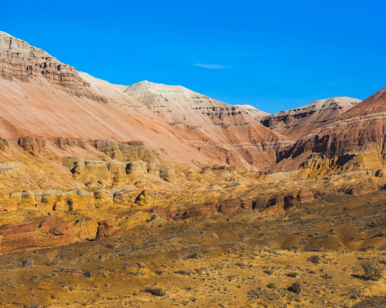 Red, cream and ochre layered slopes of the Aktau Mountains, Altyn-Emel National Park, Kazakhstan