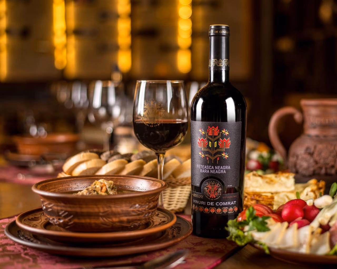 Moldovan dinner spread with Vinuri de Comrat wine and traditional dishes