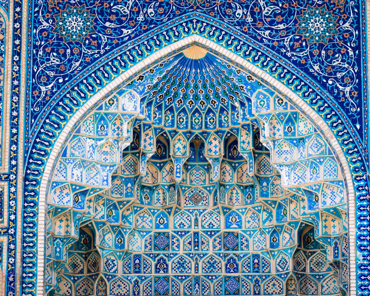 Close-up of intricate blue tilework and geometric patterns at the Gur-e Amir Mausoleum, final resting place of Tamerlane, in Samarkand, Uzbekistan.