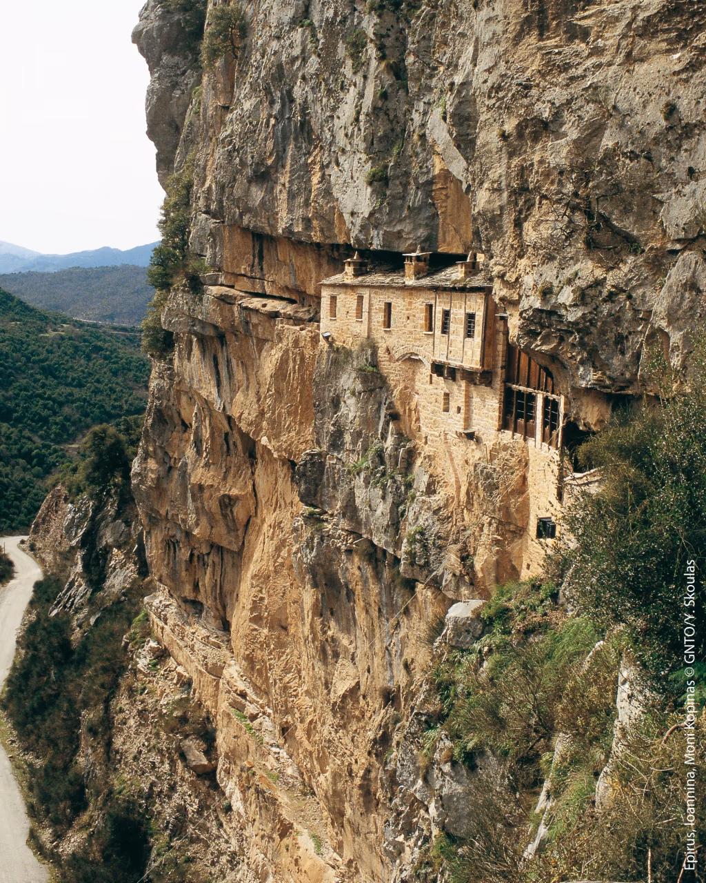 Kipina Monastery built into a dramatic rock cliff, showcasing cultural heritage in Tzoumerka, Epirus.
