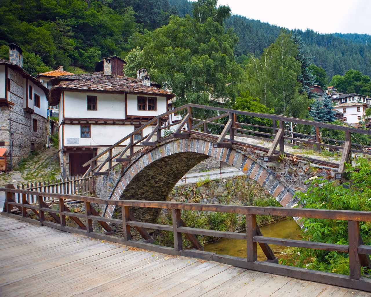 Historic stone bridge over a small stream in Shiroka Laka village, Rhodope Mountains, Bulgaria.