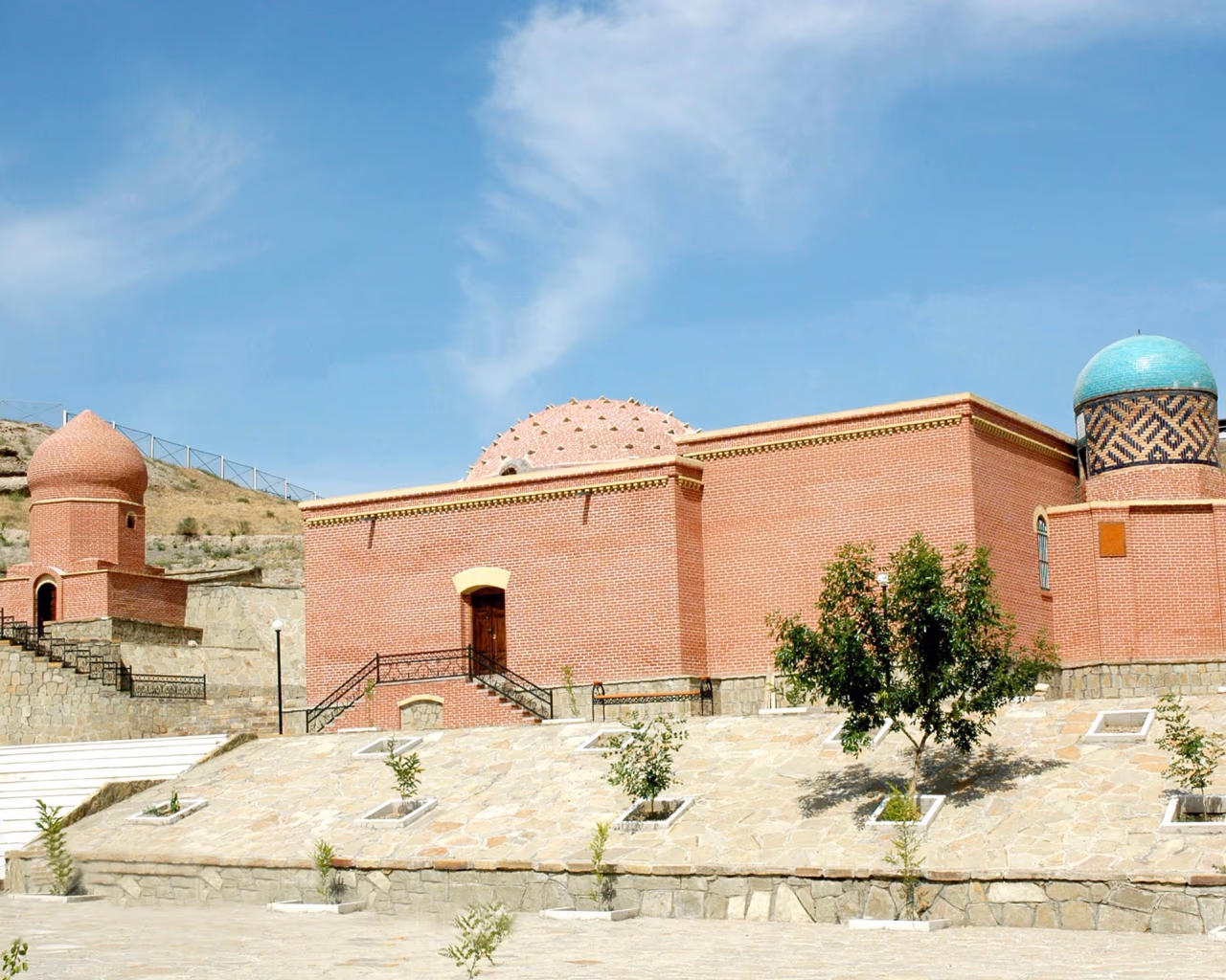 Imamzade Complex with domes and minarets blends into Nakhchivan's arid hills.