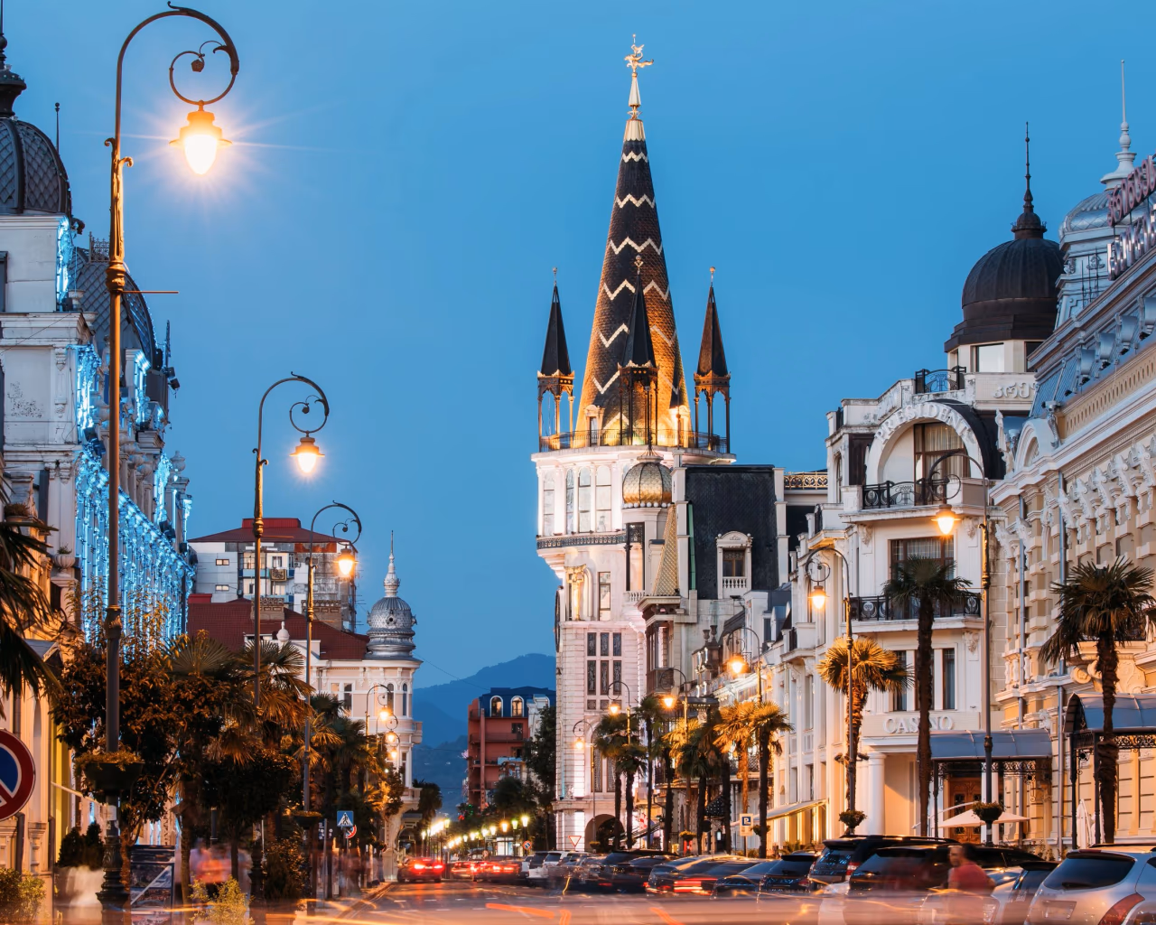 Batumi Piazza Square at night with illuminated clock tower, European-style architecture, and vibrant city lights in Batumi, Georgia