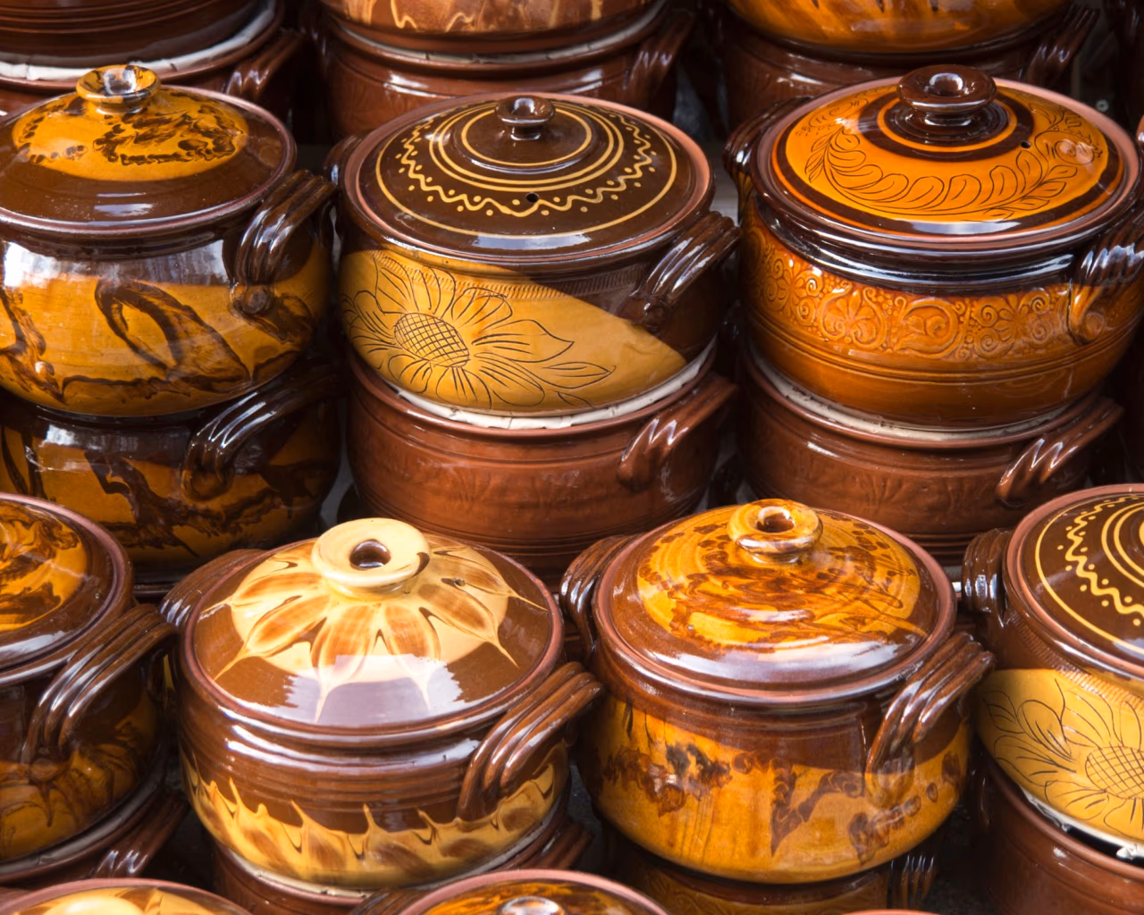 Bulgarian Pottery Display - Stacks of handcrafted, painted ceramic pots showcasing traditional Bulgarian craftsmanship.