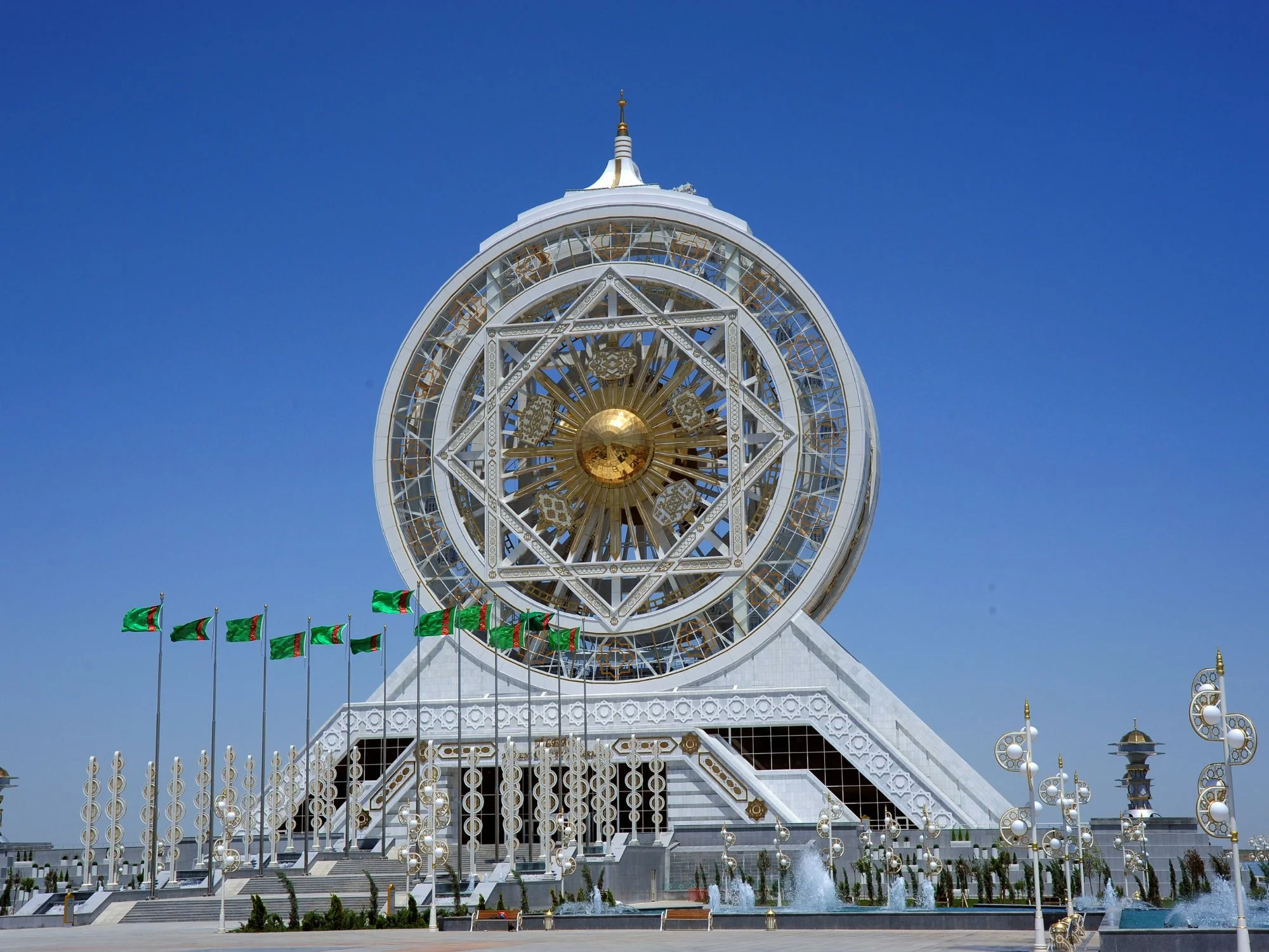 Alem Ferris wheel enclosed in a white marble star-shaped frame with Turkmen flags, Ashgabat
