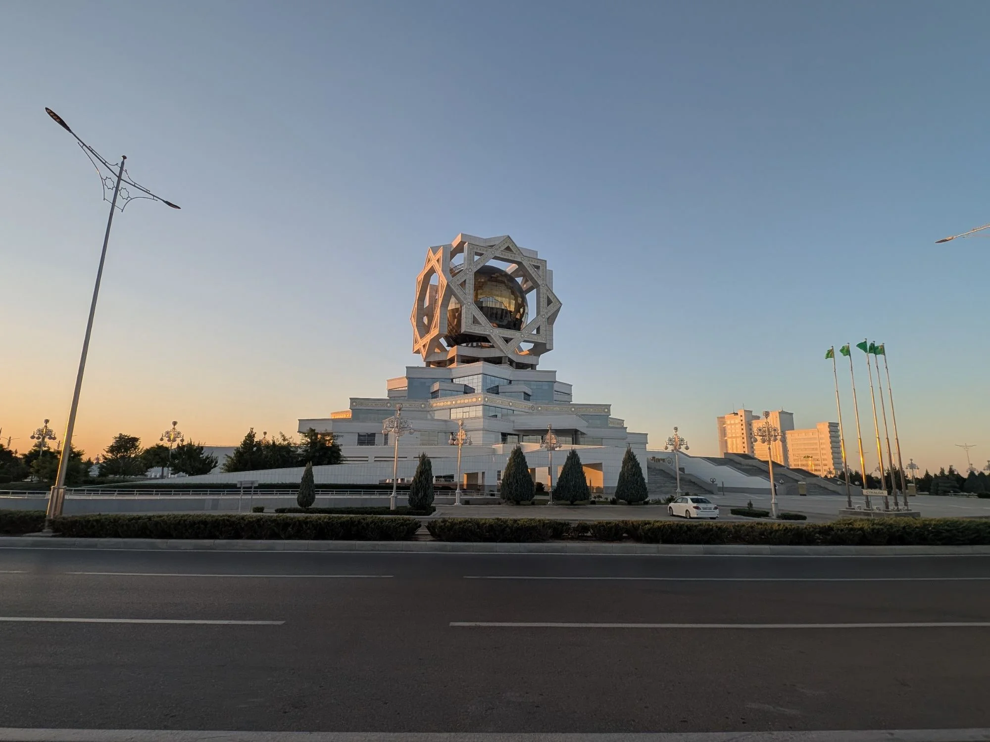 Ashgabat Wedding Palace at dusk, its golden globe set inside a star-shaped marble frame